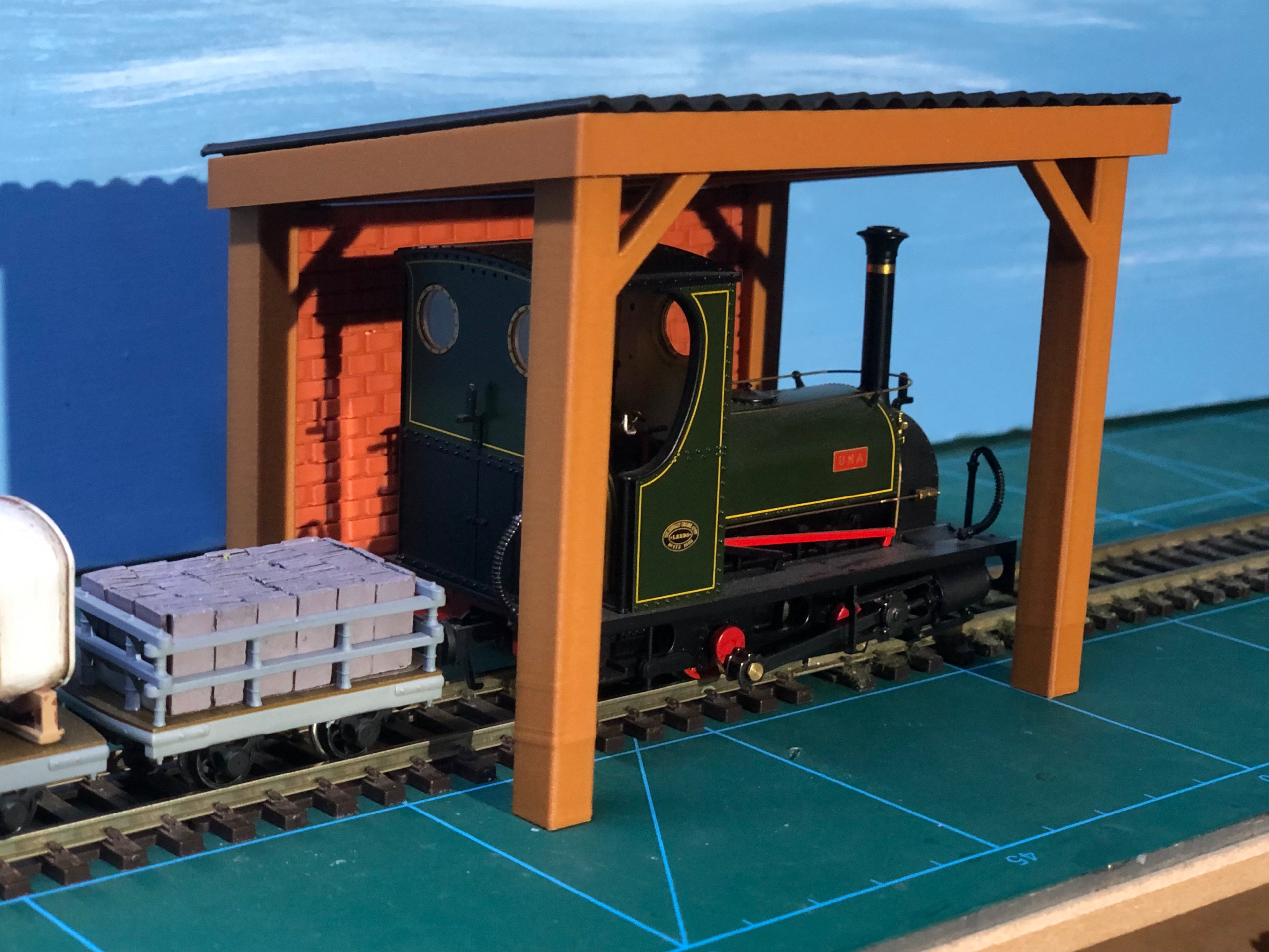 NG7 7mm scale engine stand model with corrugated roof, wooden sides and brick back wall for ON30 narrow gauge layouts