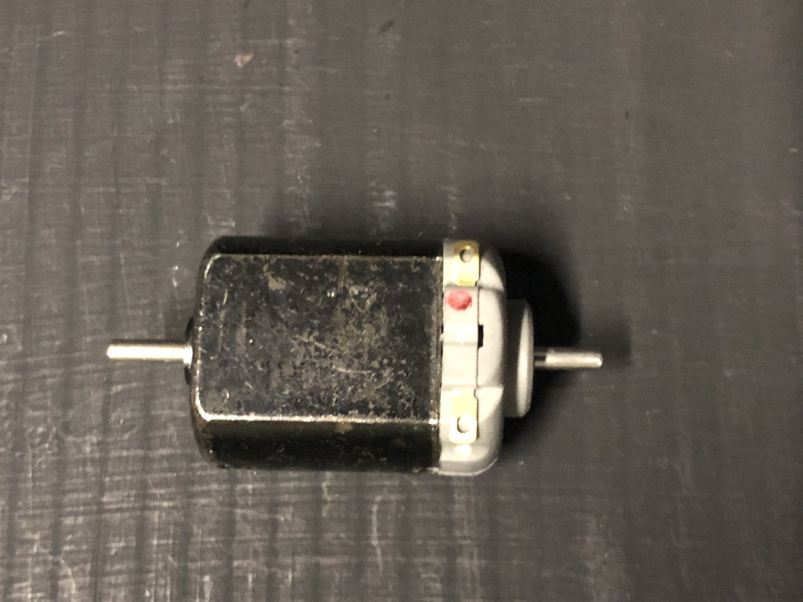 Close-up of a 5-pole 12V motor upgrade for Hornby Smokey Joe 0-4-0 OO gauge chassis, showing shaft ready for worm gear fitting