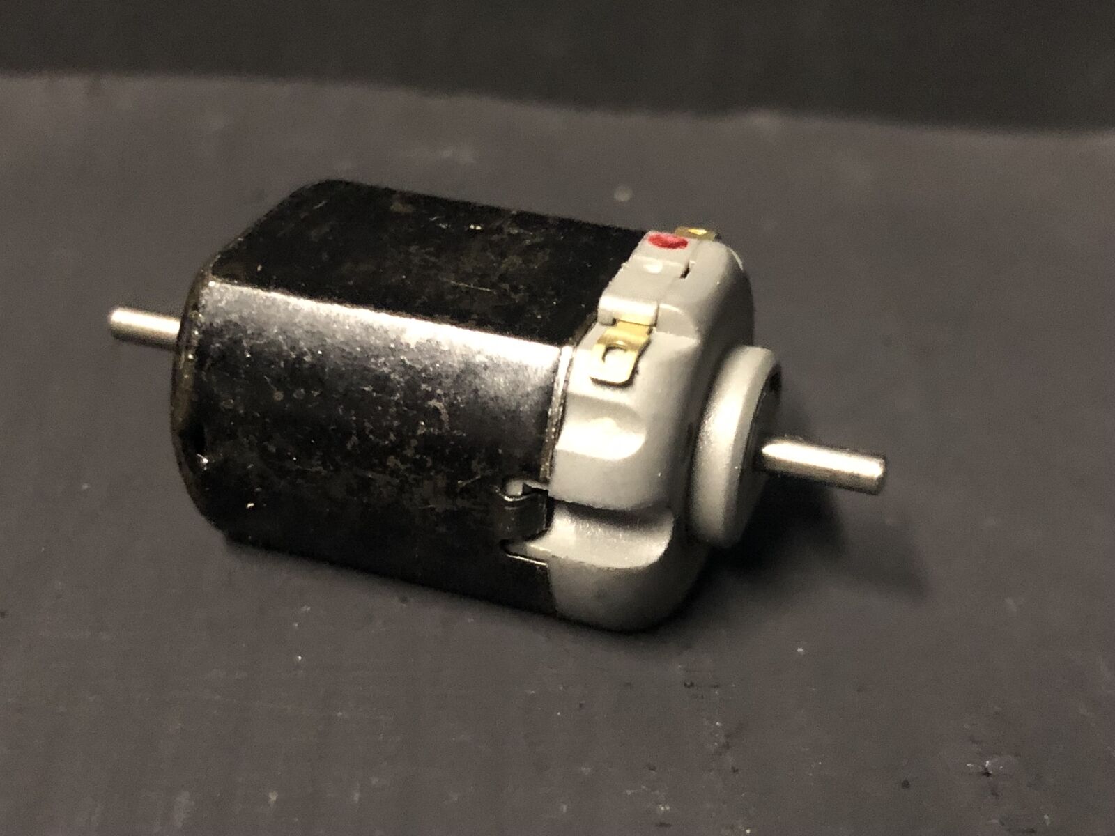 Close-up of a 5-pole 12V motor upgrade for Hornby Smokey Joe 0-4-0 OO gauge chassis, showing shaft ready for worm gear.