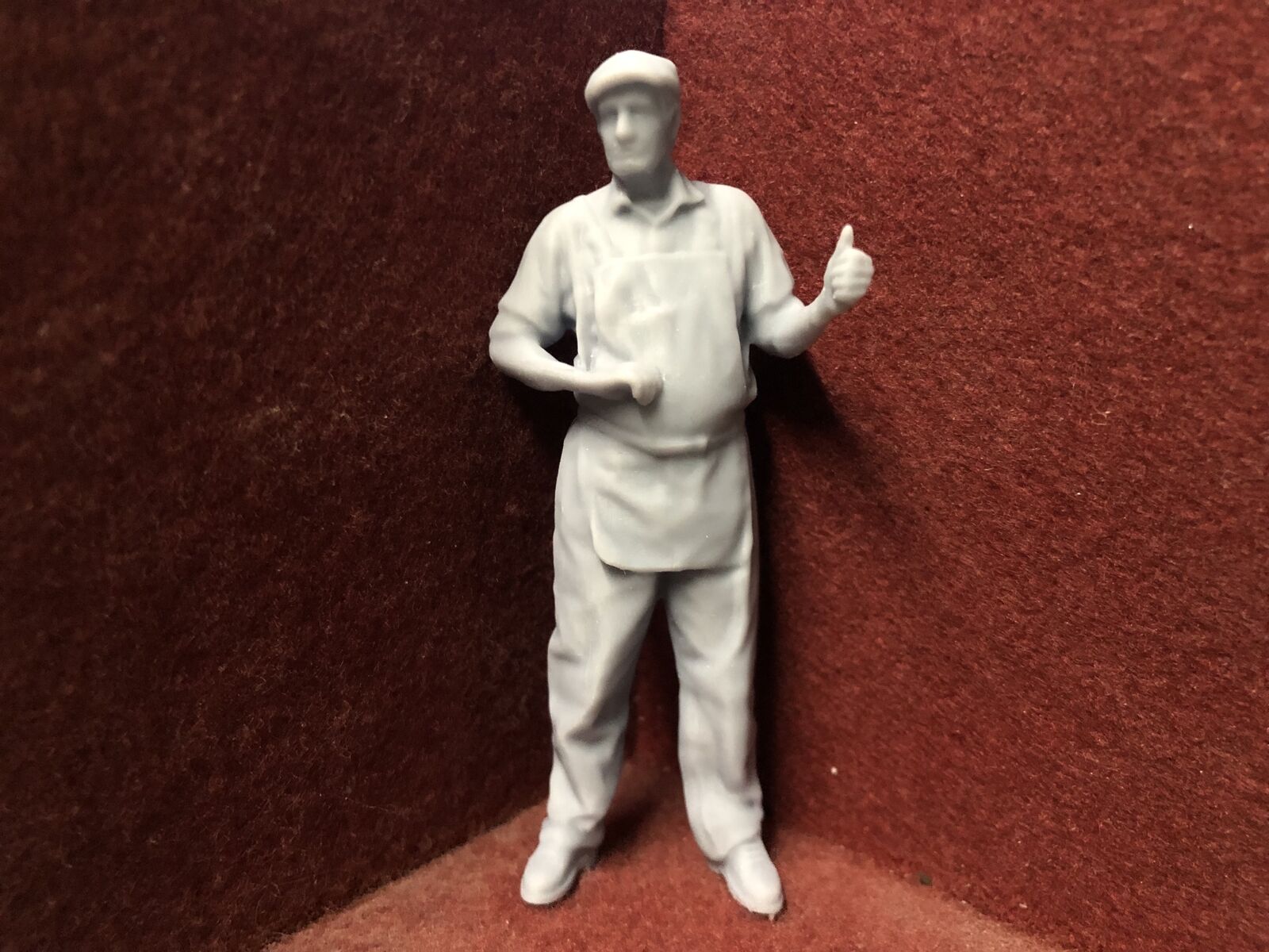 Unpainted 16mm 1:19 scale SM32 driver figure in flat cap giving a thumbs up for garden model railways