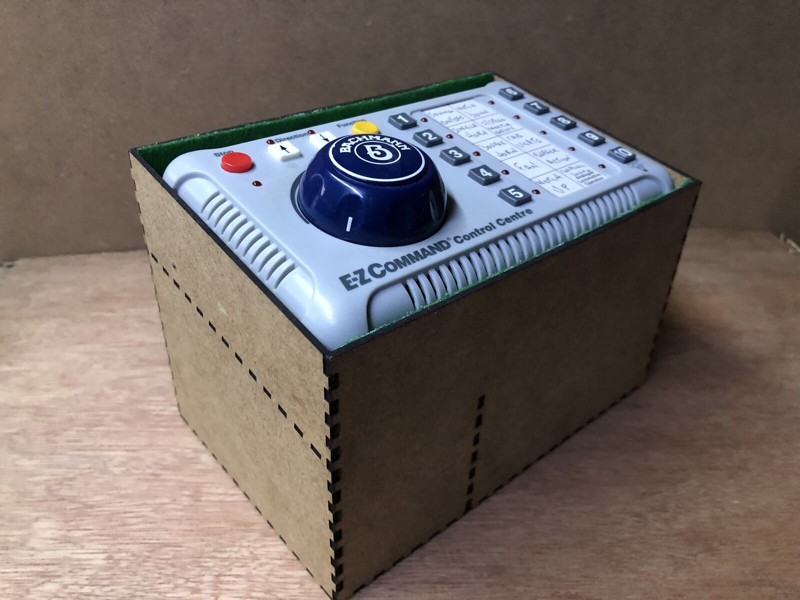 Desktop stand and tidy kit for the Bachmann EZ DCC model railway controller, with angled holder and storage space for leads underneath