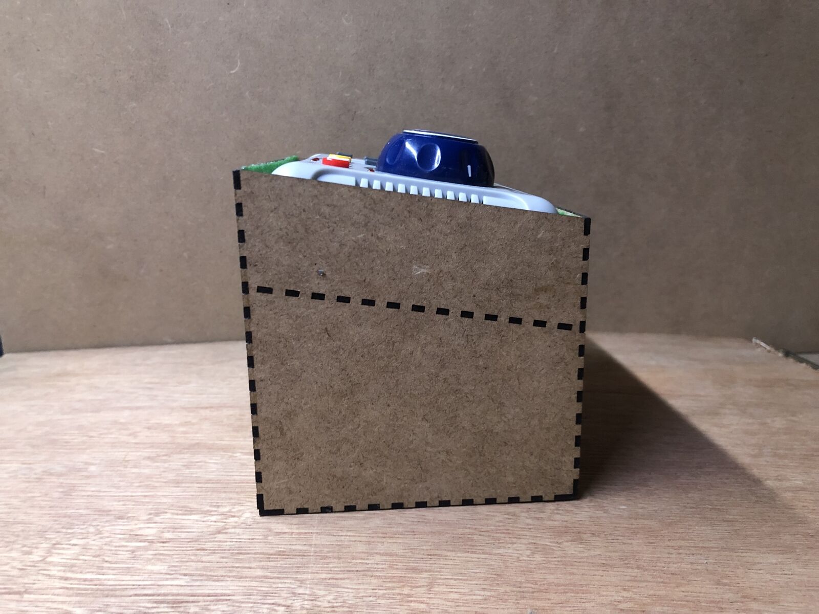 Desktop stand and tidy kit holding a Bachmann EZ DCC controller, angled for ergonomic use with cable storage underneath