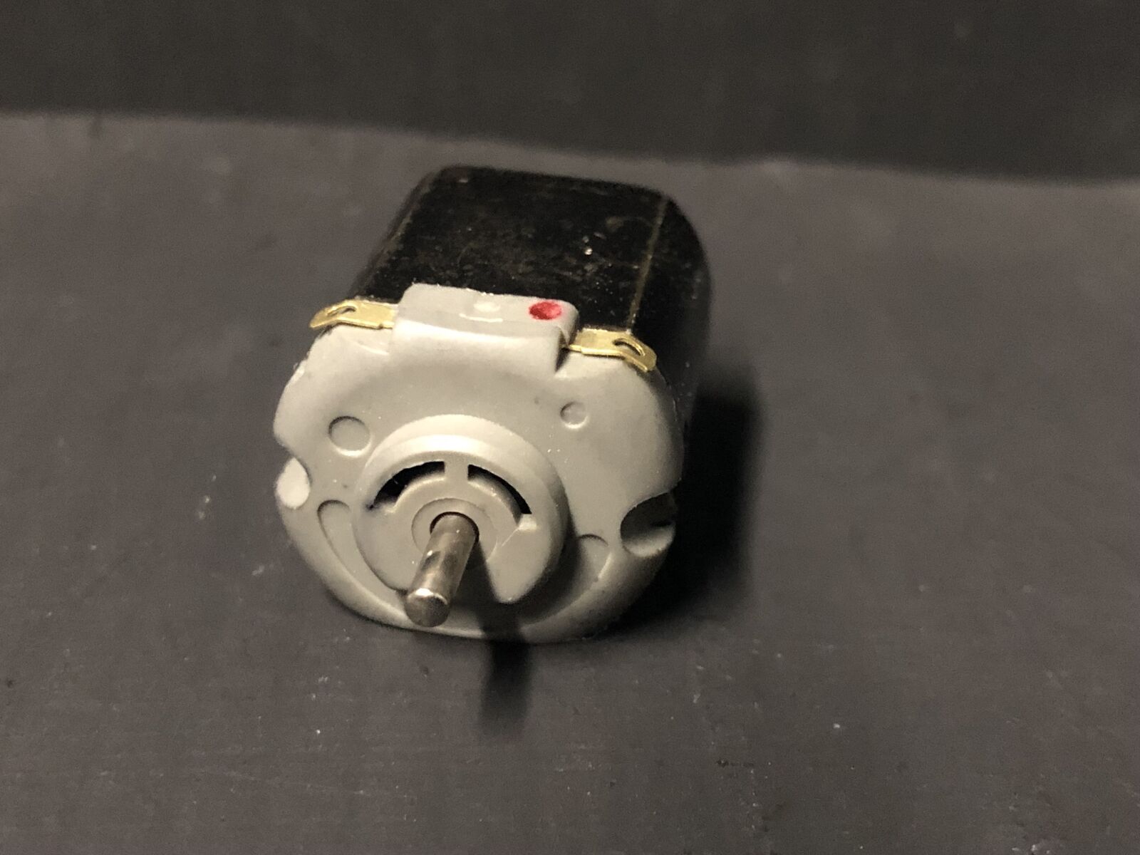 Close-up of a 5-pole replacement motor for Hornby Smokey Joe 0-4-0 OO gauge chassis, showing shaft ready for worm gear.