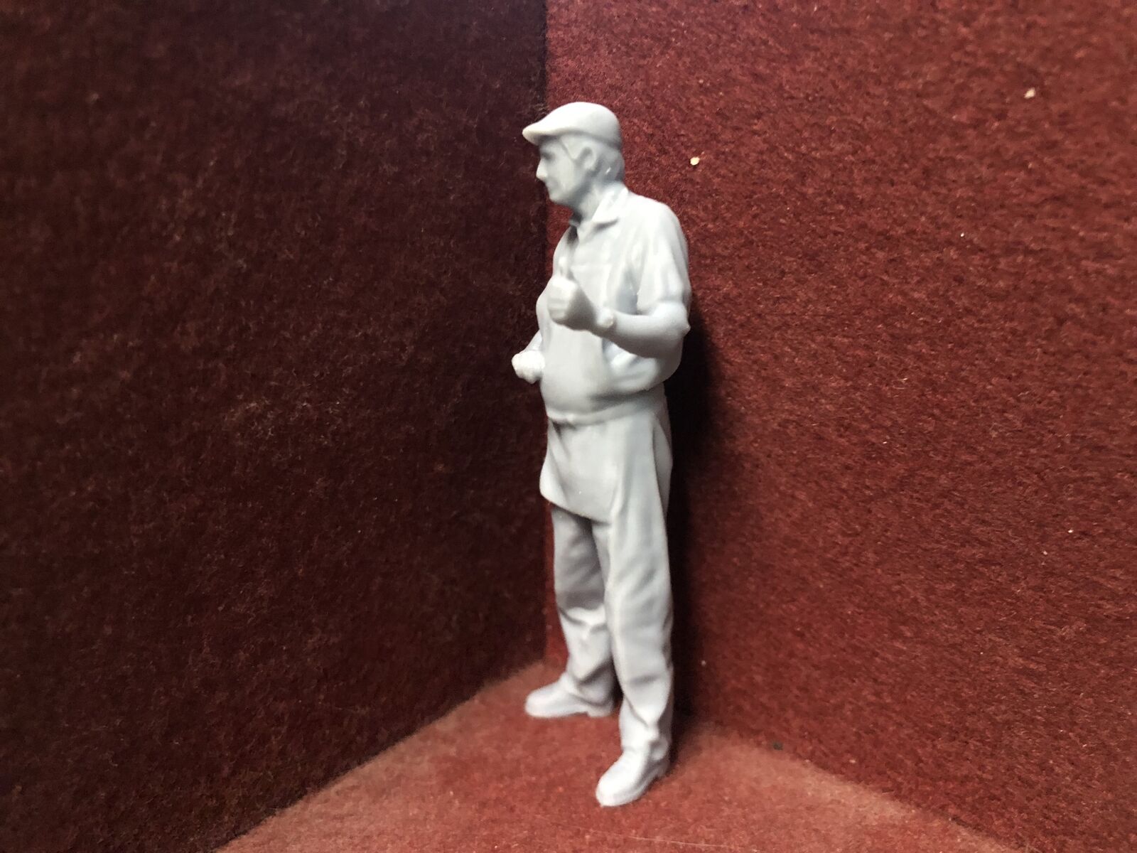 Unpainted 16mm 1:19 scale SM32 driver figure with flat cap giving a thumbs up for garden railway layouts