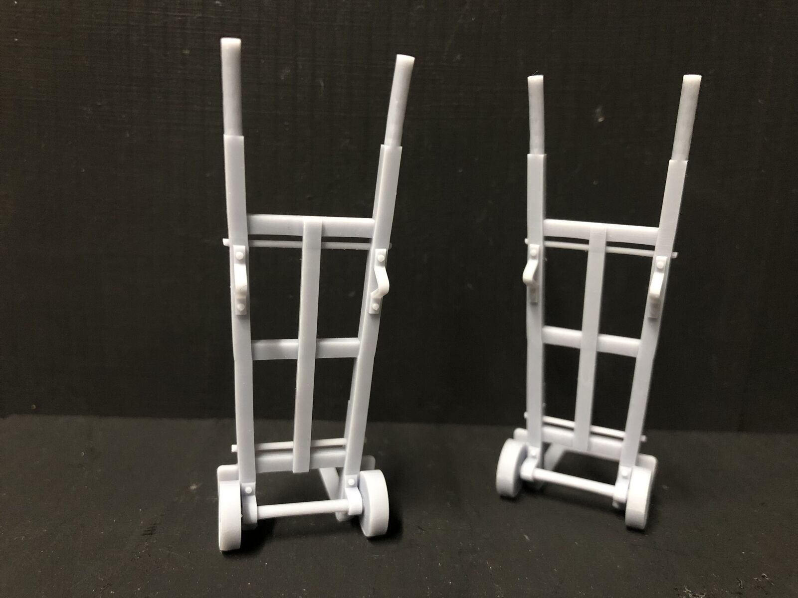 Unpainted 16mm scale resin model sack trolleys, supplied as two grey platform or workshop accessories for garden railway scenes