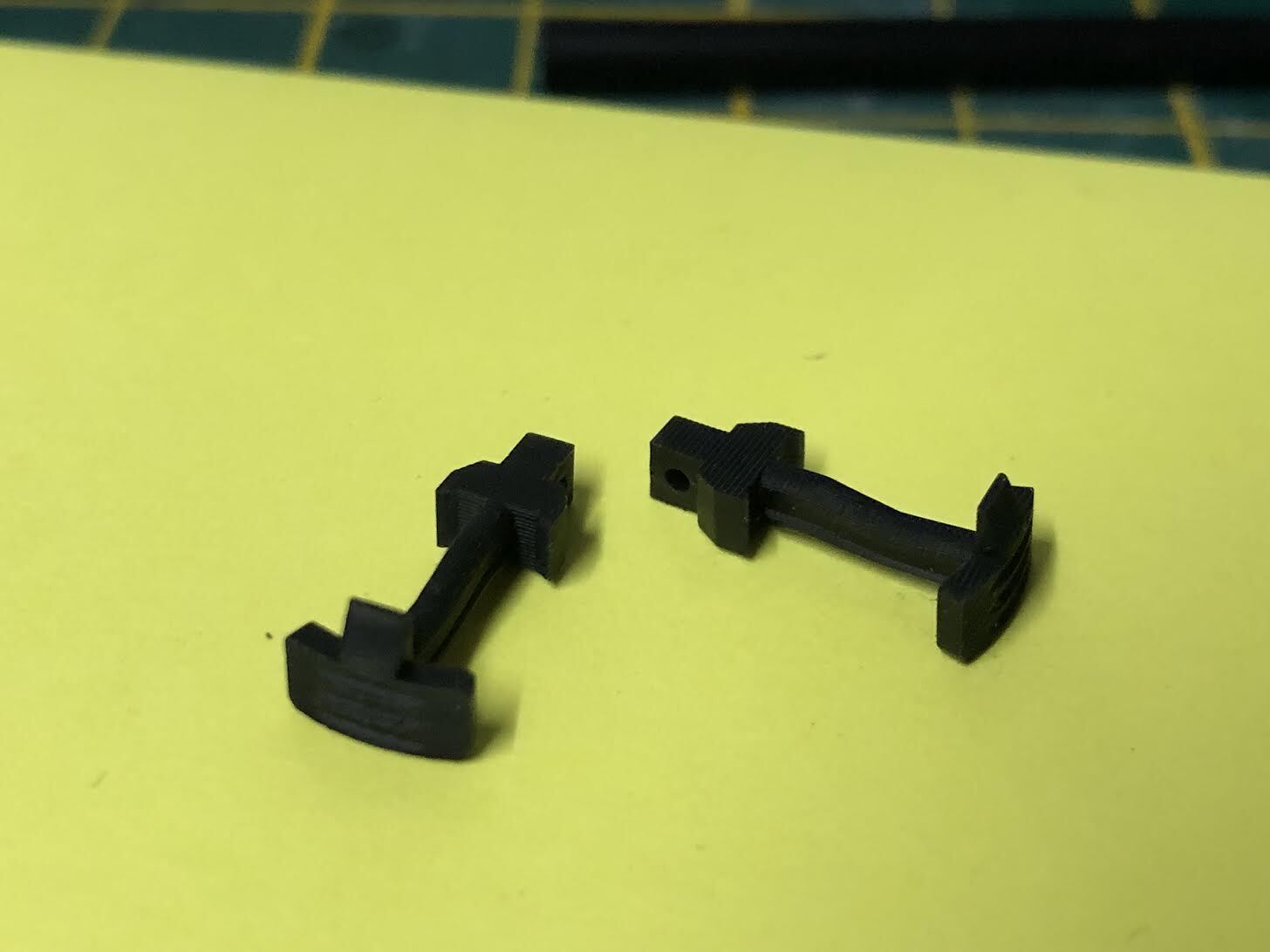 Set of four pairs of OO9 narrow gauge hook couplings for Kato 11-109 model railway chassis, shown laid out for detail.