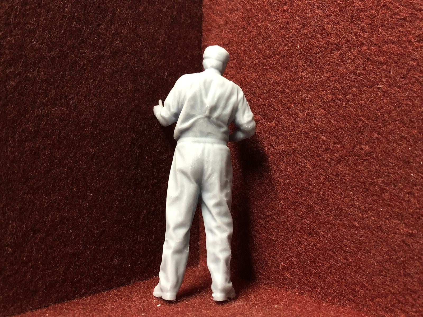 Unpainted G-scale 1:22 driver figure with flat cap giving a thumbs up, suitable for GN15 narrow gauge model railways