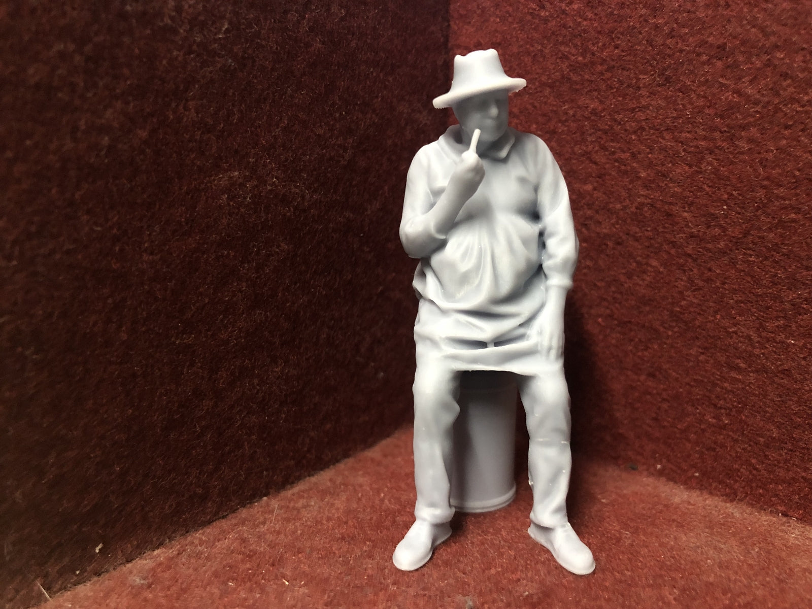 Unpainted G-scale 1:22.5 farmer figure sitting on a milk churn for GN15 or garden railway layouts