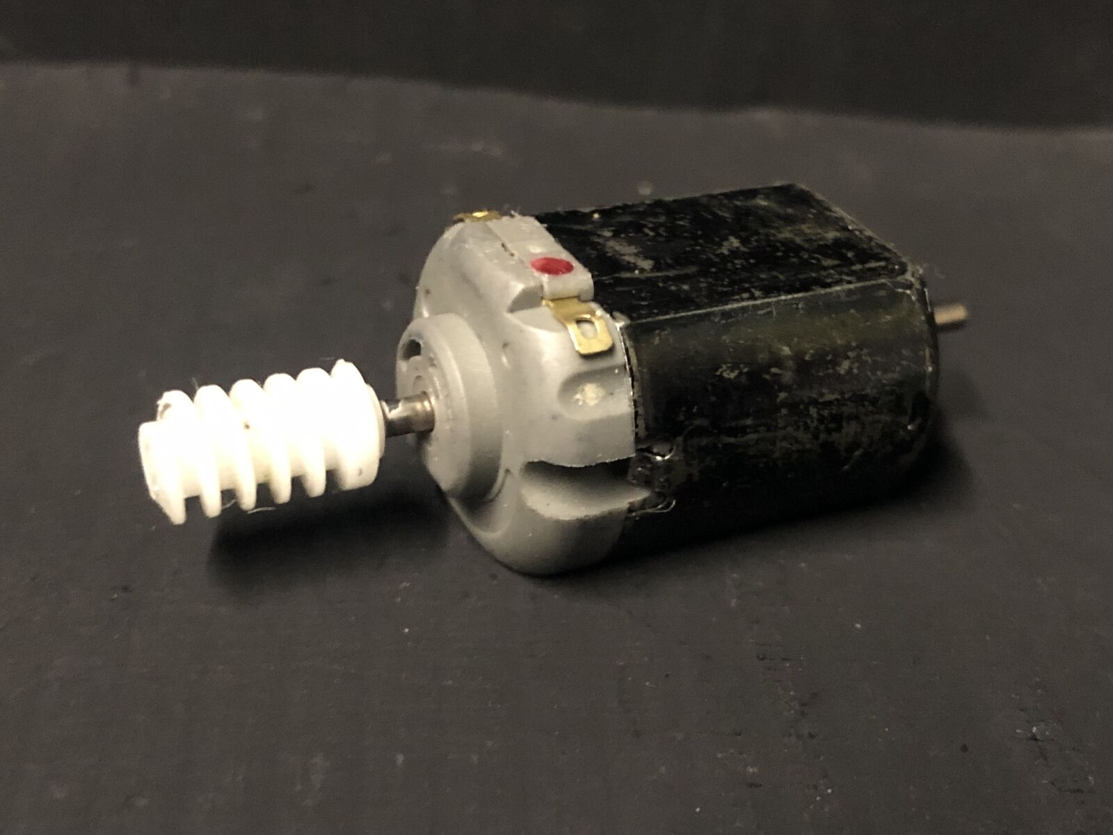 Close-up of a 5-pole 12V motor upgrade for a Hornby Smokey Joe 0-4-0 chassis, shown ready to replace the original motor