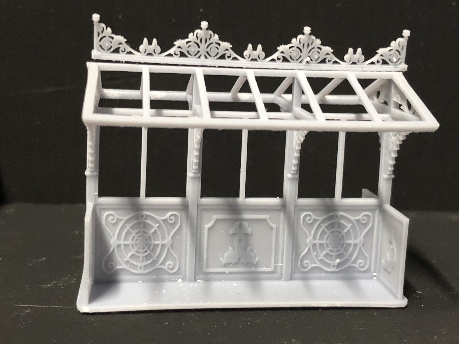 OO9 gauge Edwardian promenade shelter kit with glazed roof panels and two pedestrian figures for seaside or park model railway scenes