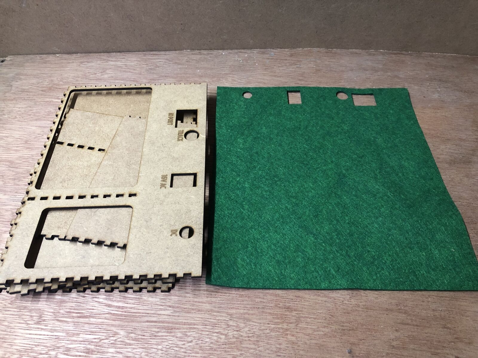 Desktop stand and tidy kit holding a Bachmann EZ DCC model railway controller with space below for power brick and leads