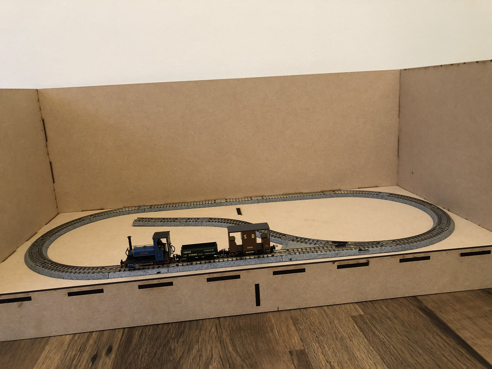 Laser-cut 4mm MDF model railway diorama case, 60x30x25cm, shown with an OO/4mm scale oval layout using Kato-style track