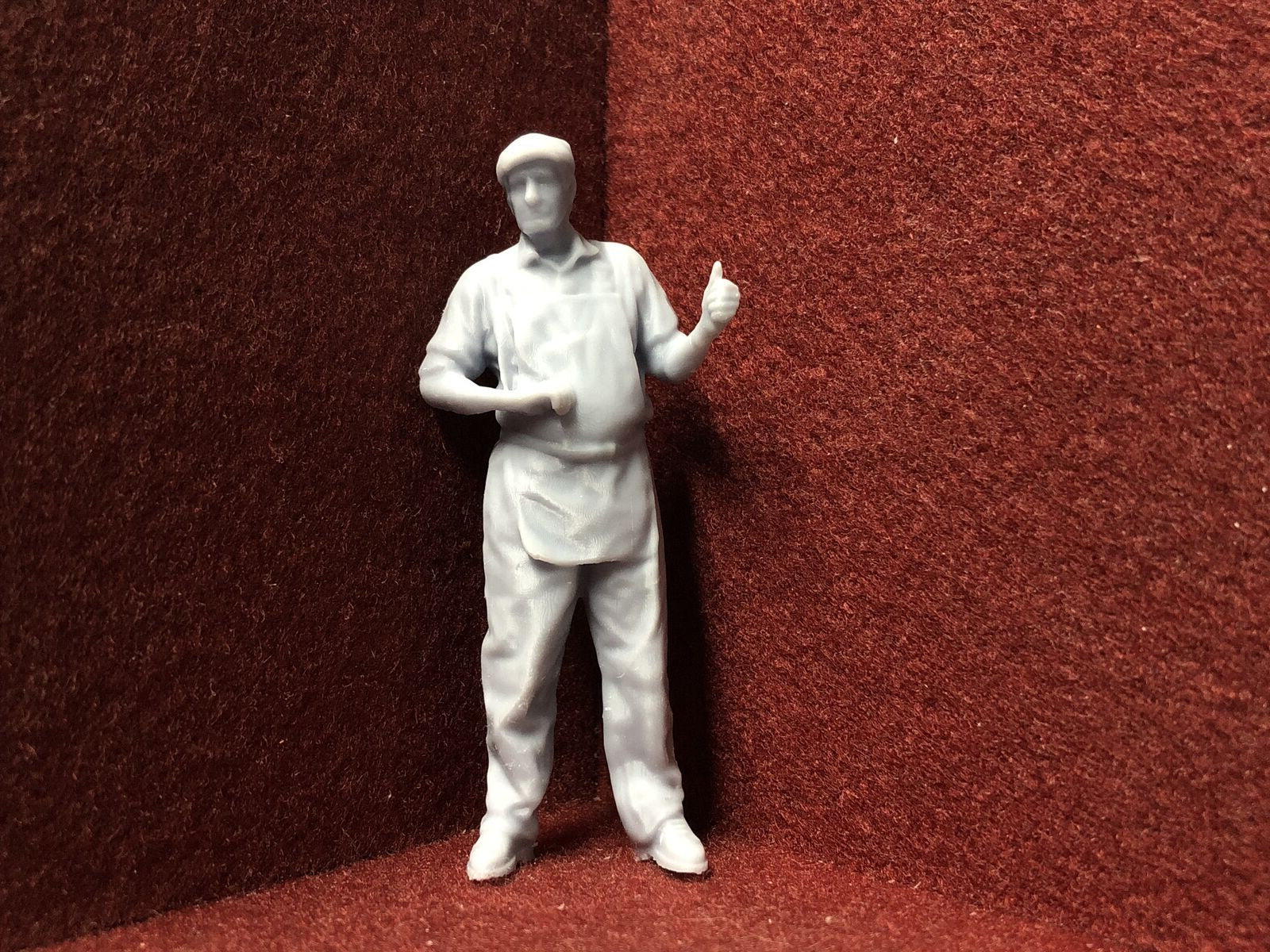 Unpainted G scale 1:22 driver figure with flat cap giving thumbs up, for GN15 narrow gauge model railway layouts