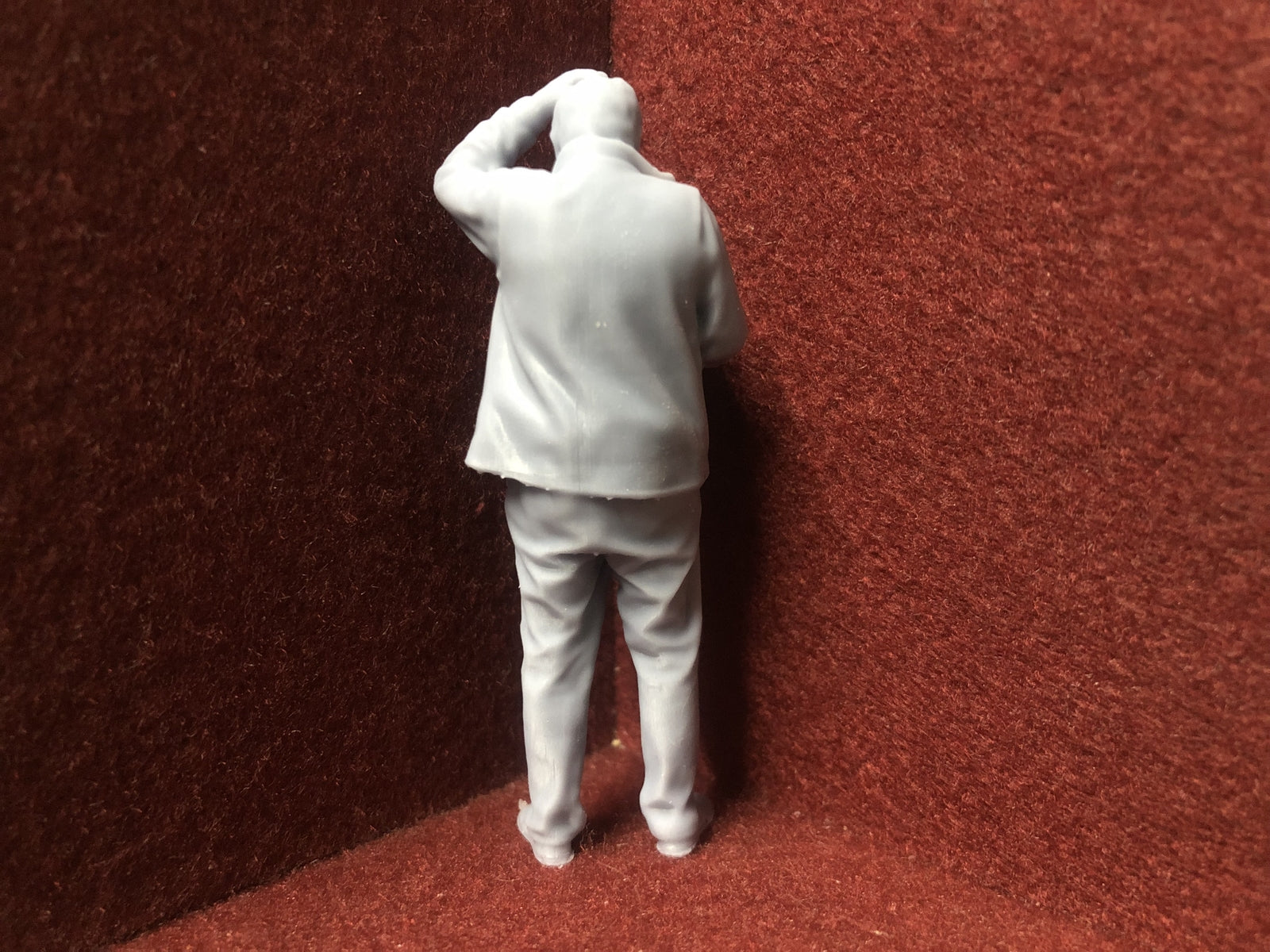 Unpainted G-scale 1:22.5 driver figure for GN15 layouts, 3D scanned from a real person, holding a manual and looking perplexed