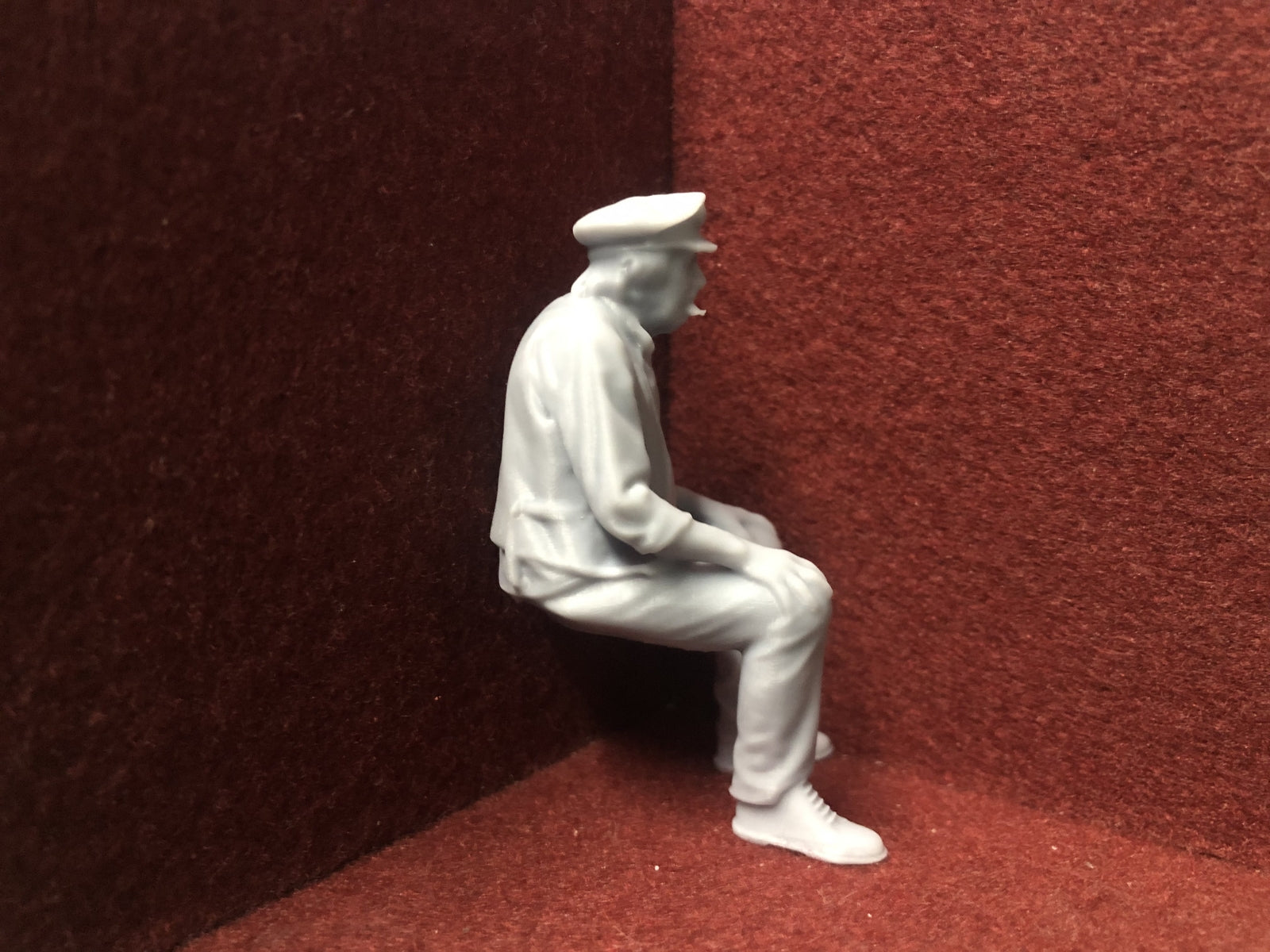 Unpainted 16mm 1:19 scale seated male figure wearing a cap for SM32 garden railway layouts or locomotive cabs
