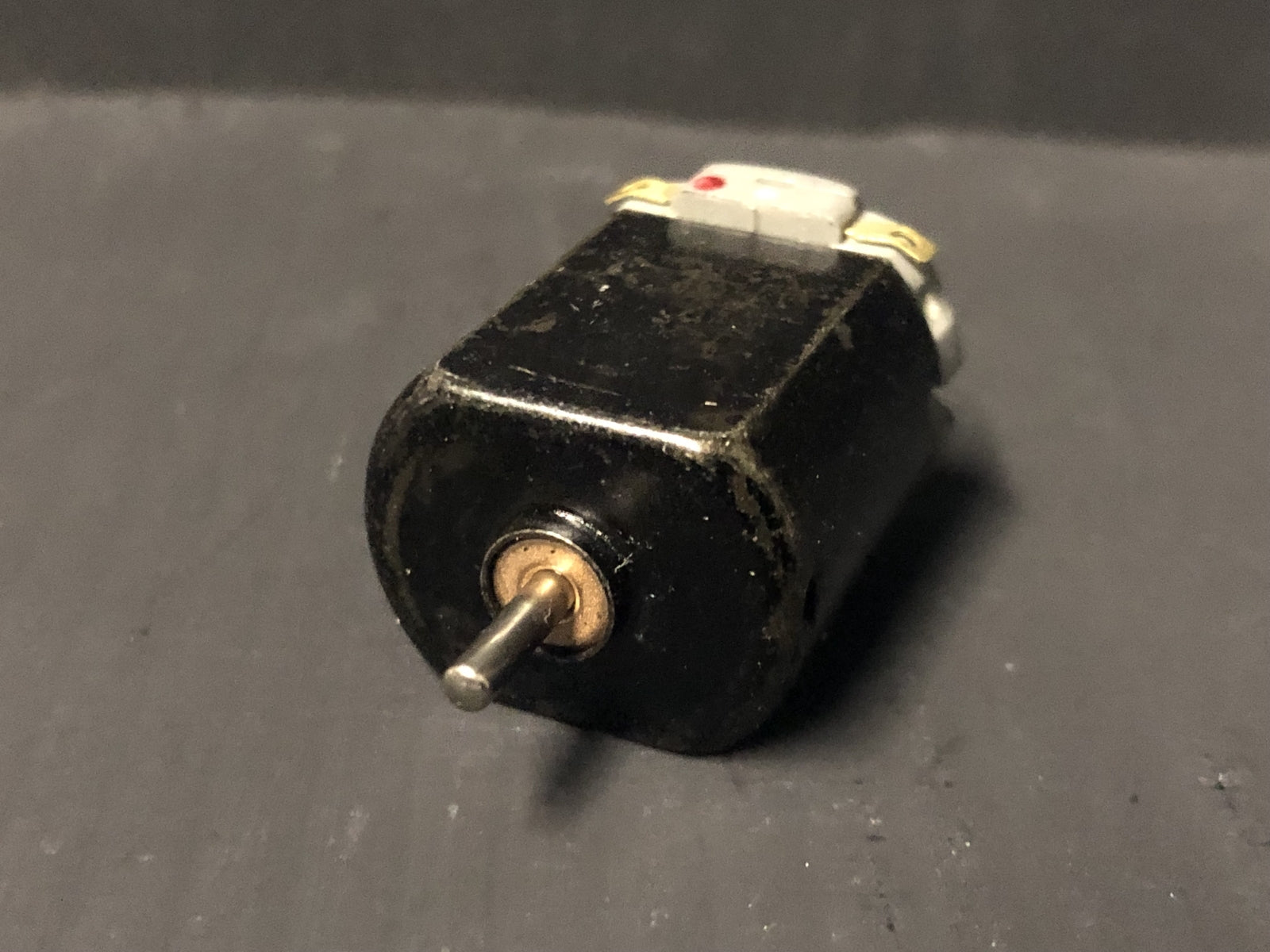 Close-up of a 5-pole 12V motor upgrade for a Hornby Smokey Joe 0-4-0 chassis, shown ready to replace the original motor.