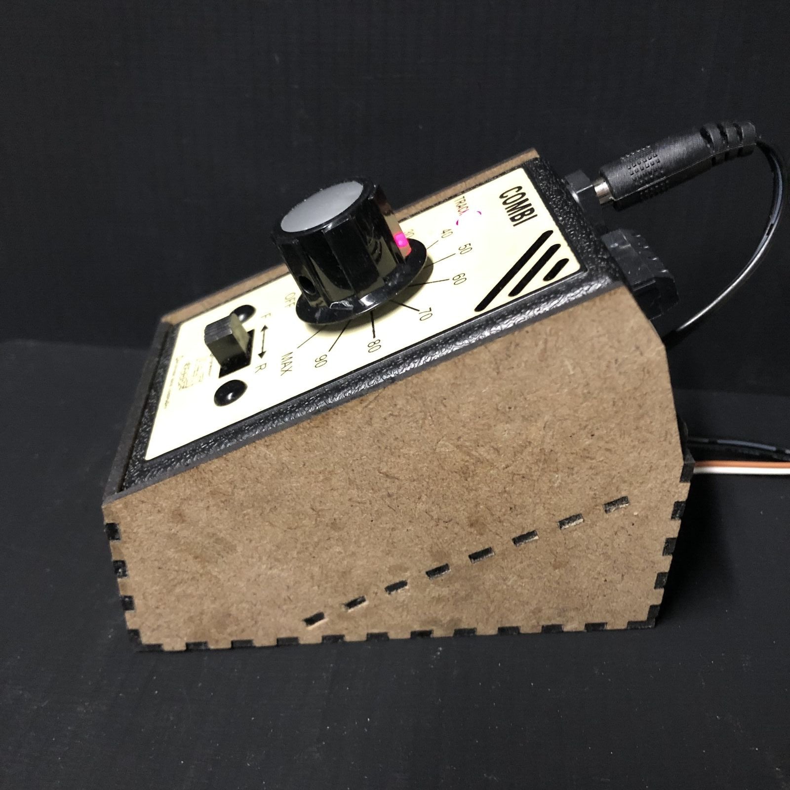 OO9 scale desktop caddy kit shown holding a Gaugemaster Combi model railway controller with cable cutouts and fixing holes