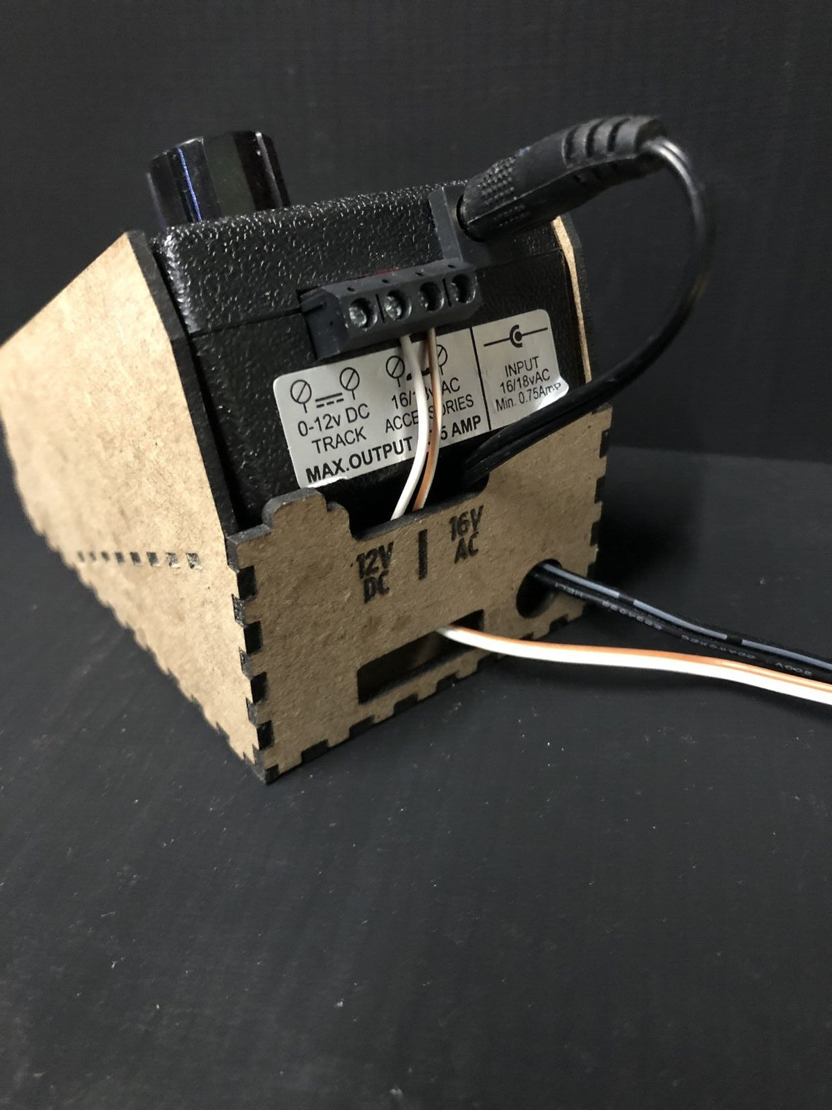 OO9 scale desktop caddy kit shown holding a Gaugemaster Combi model railway controller with cable cutouts and fixing holes