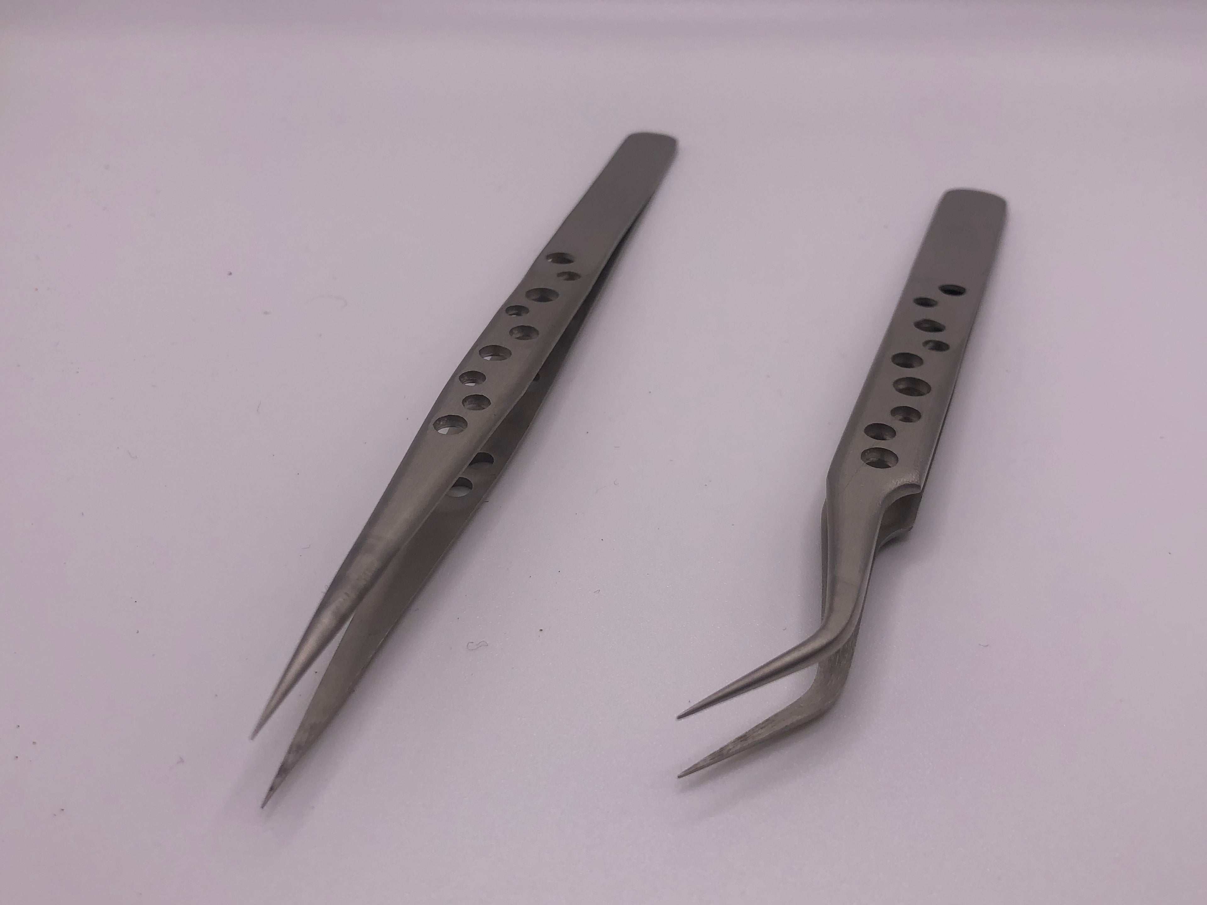 Pair of precision stainless steel tweezers with straight and curved fine tips and drilled anti-static handles for detailed modelling work