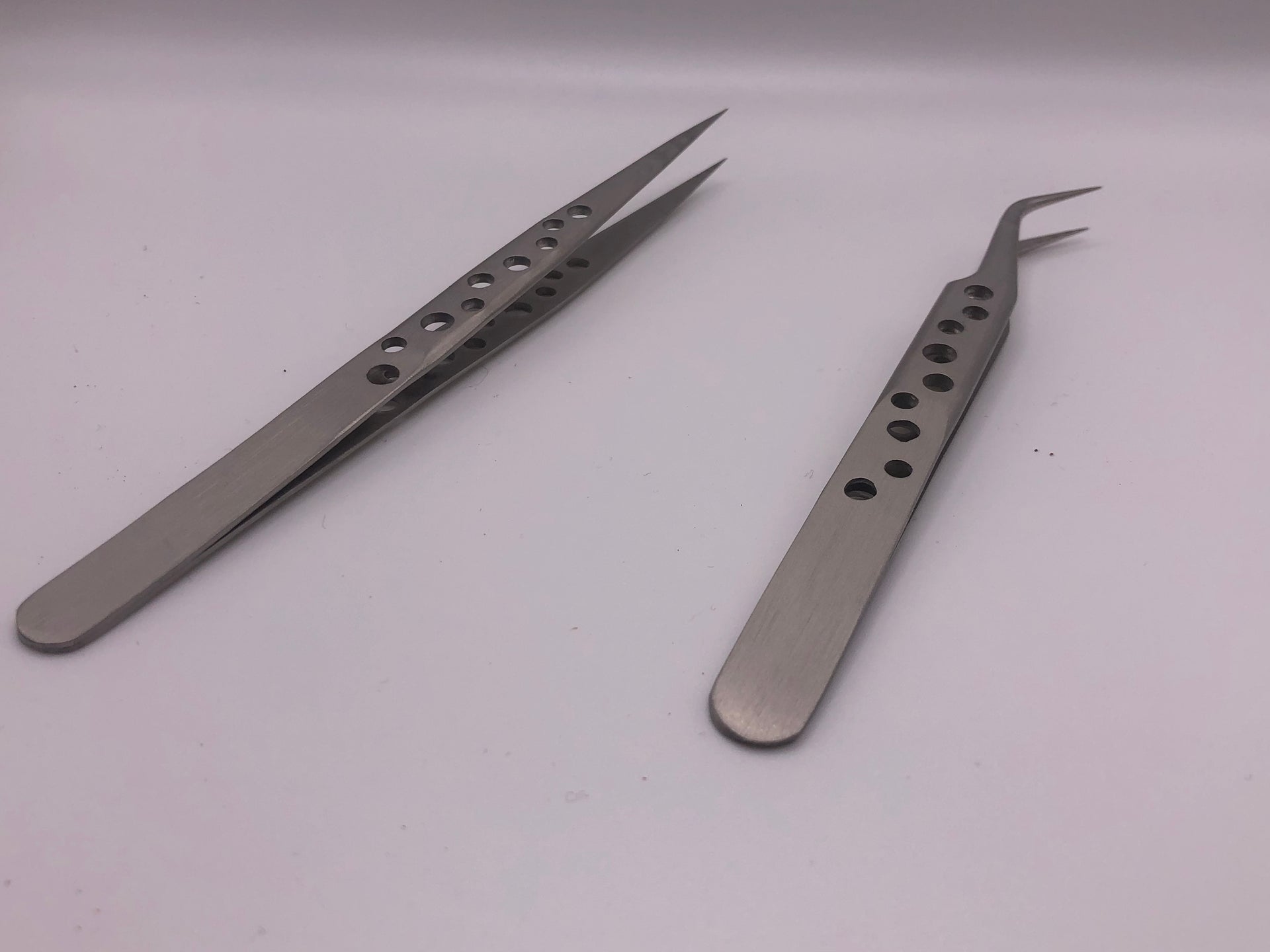Pair of precision stainless steel tweezers with straight and curved fine tips, drilled anti-static handles for detailed modelling work