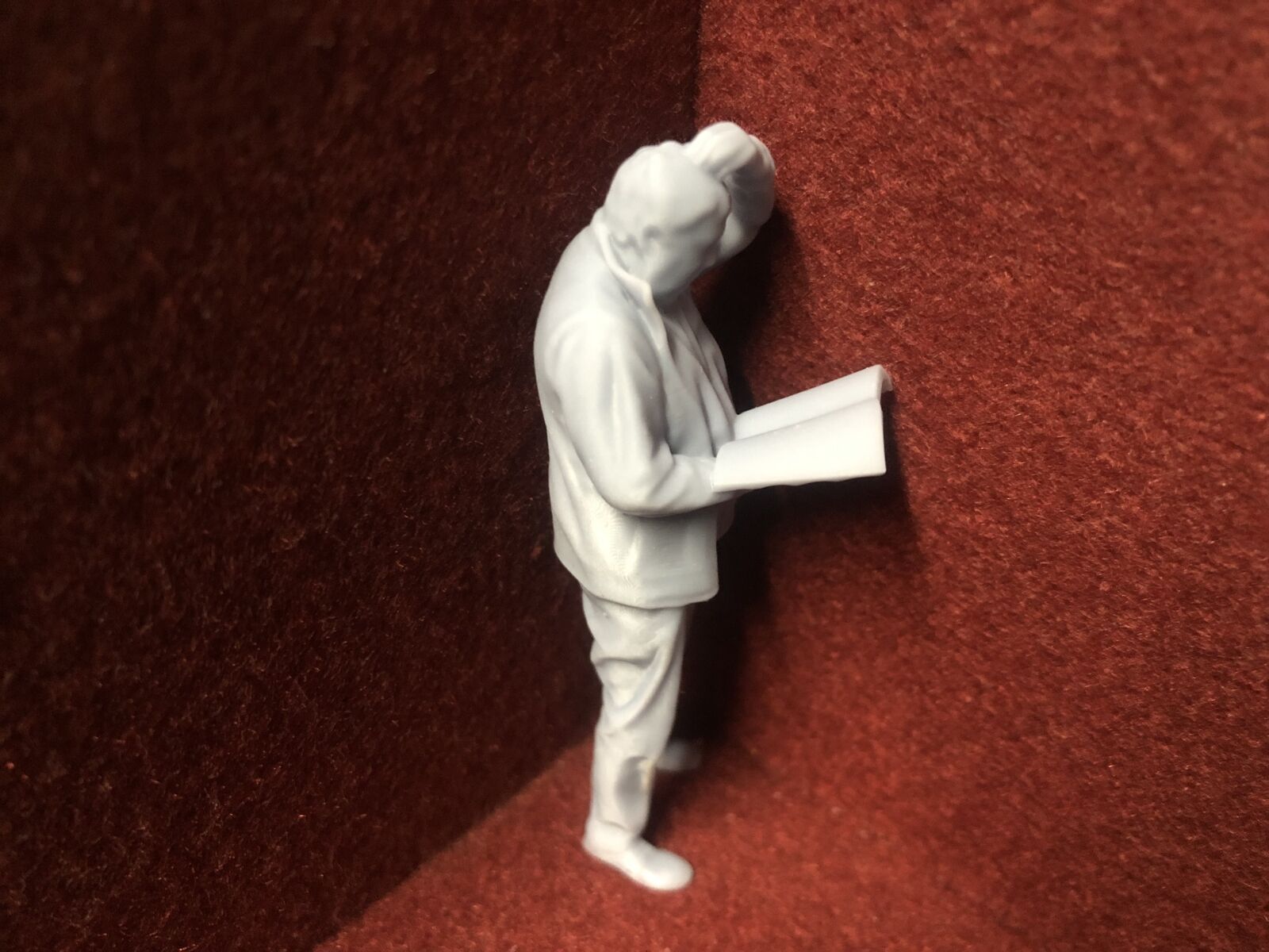 Unpainted G-scale 1:22.5 driver figure for GN15 layouts, holding a manual and looking perplexed, 3D scanned from a real person