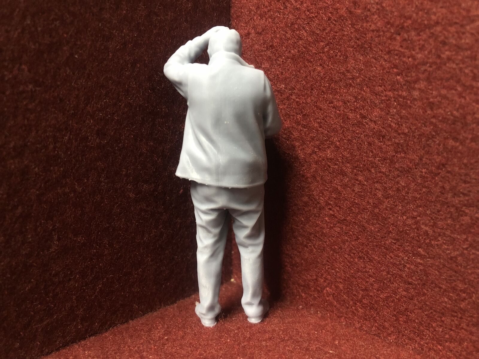 Unpainted G-scale 1:22.5 driver figure for GN15 layouts, 3D scanned from a real person, holding a manual and looking perplexed