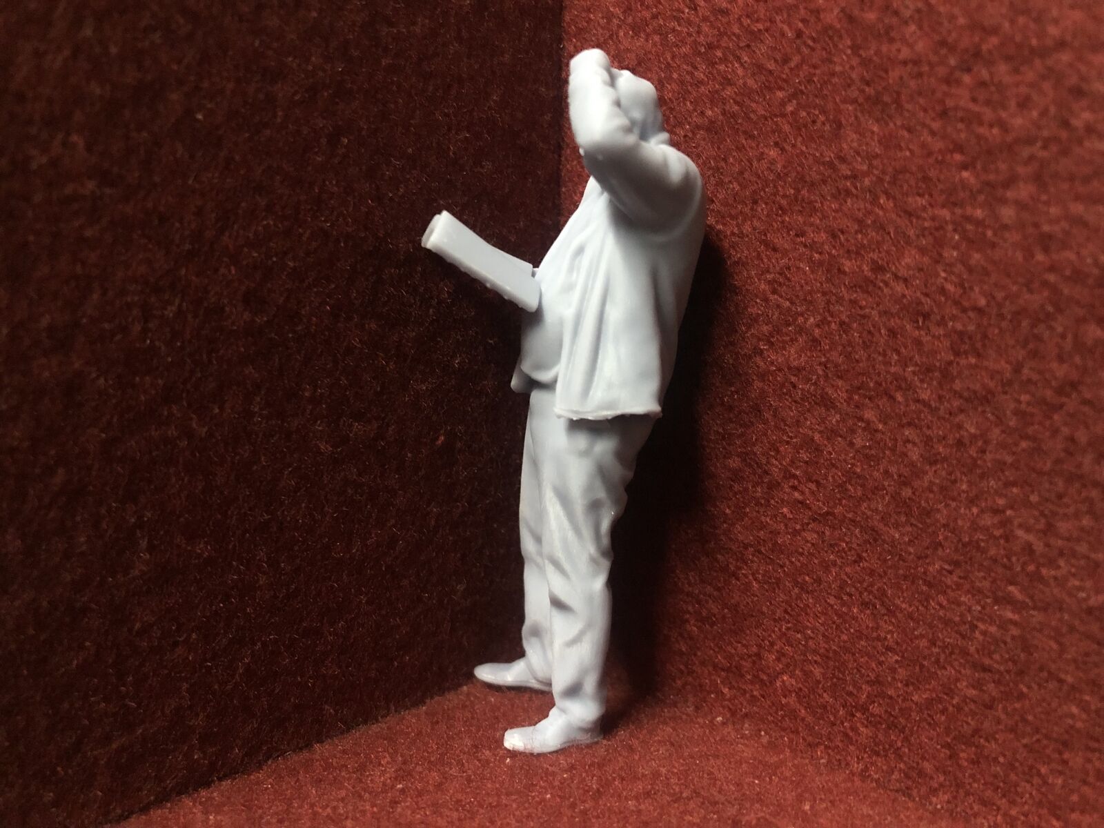 Unpainted G-scale 1:22.5 driver figure holding a manual, 3D scanned from a real person, suitable for GN15 model railways.