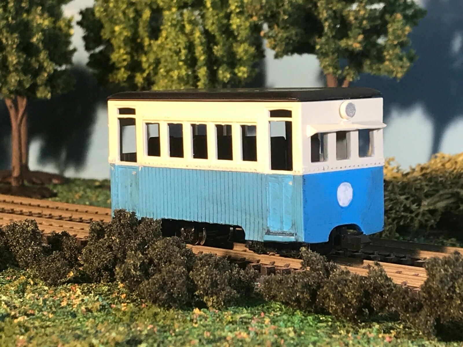 Unpainted OO9 narrow gauge prototype railbus body, roof and interior kit shown fitted to a compatible Kato 103/109/105 chassis