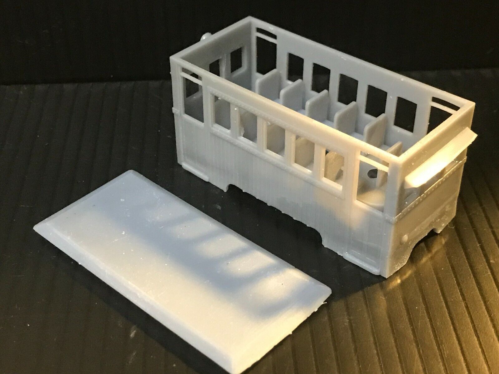 Unpainted OO9 narrow gauge prototype railbus body, roof and interior kit shown fitted to a Kato 103/109/105 chassis.