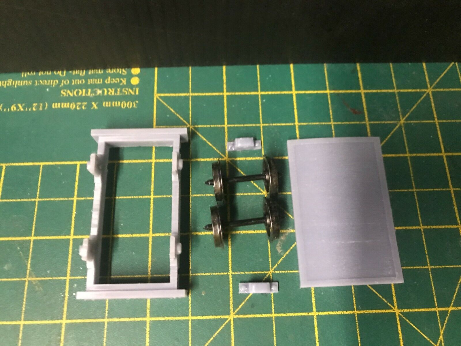 Gn15 narrow gauge flat wagon kit shown assembled on 16.5mm track with optional 12.5mm wheelset displayed alongside