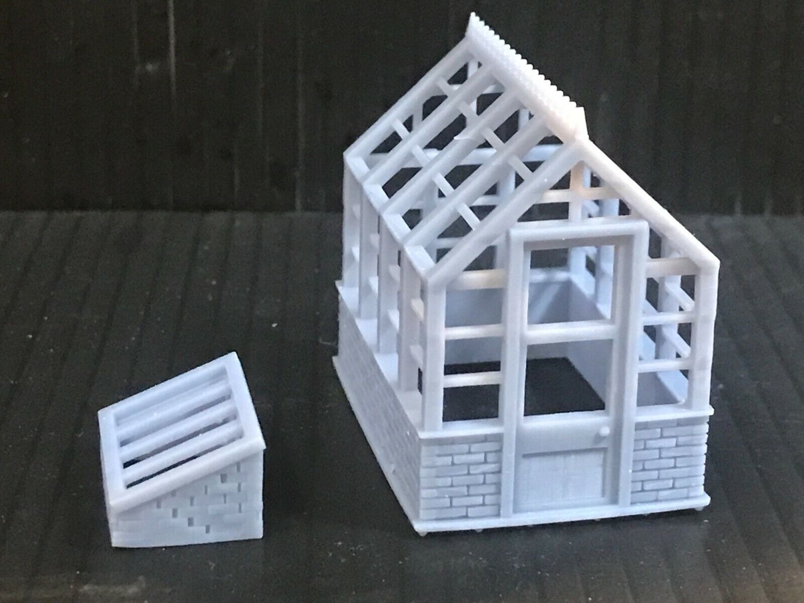 Unpainted 00 gauge resin kit with two Victorian-style greenhouses and two cold frames for model railway gardens