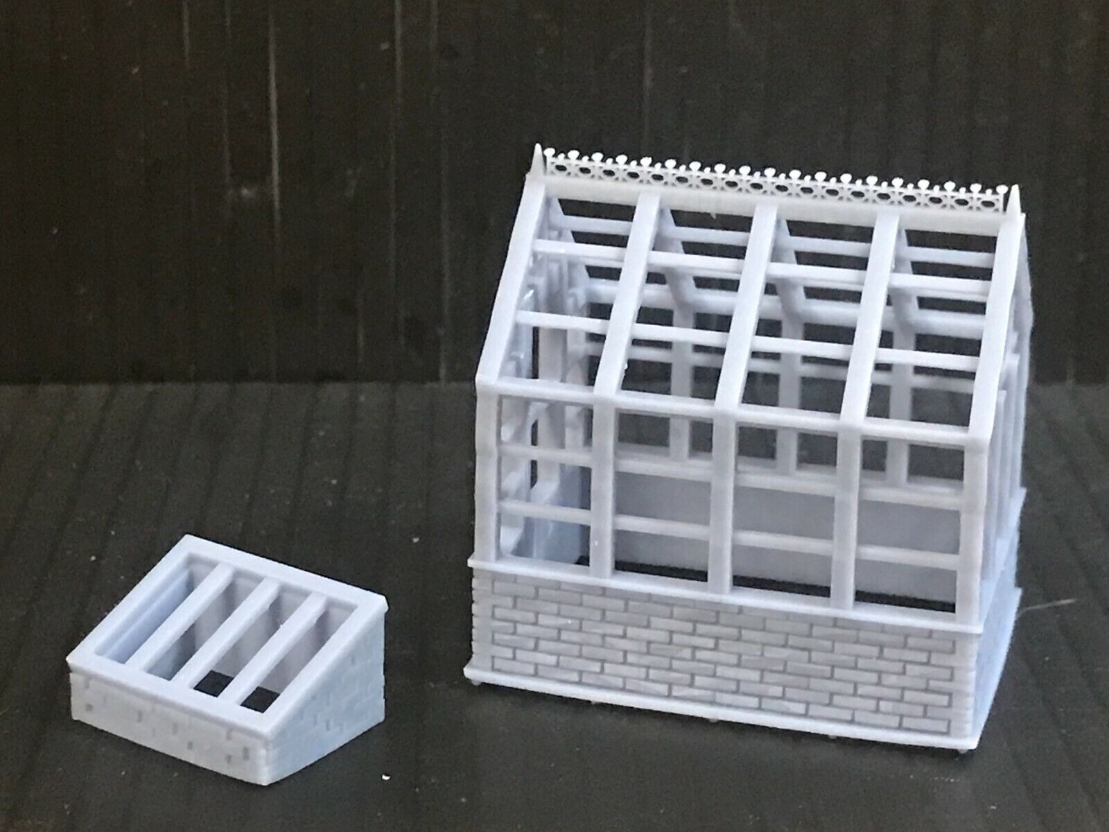 Unpainted 00 gauge resin kit of two Victorian-style greenhouses with matching cold frames for model railway gardens