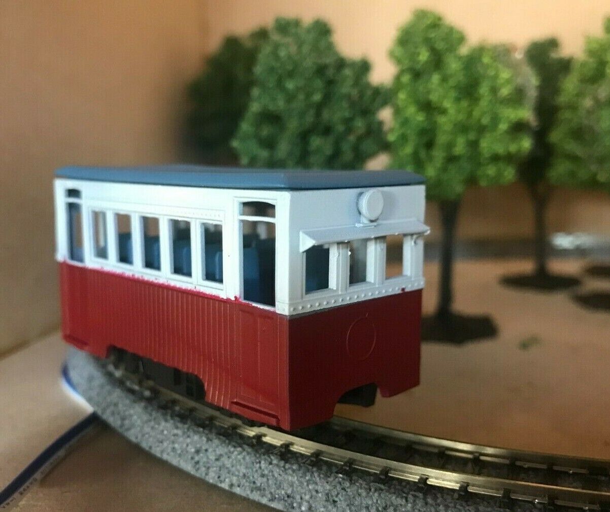 Unpainted OO9 narrow gauge prototype railbus body kit designed to fit KATO 103, 109 or 105 chassis, shown with separate roof and interior