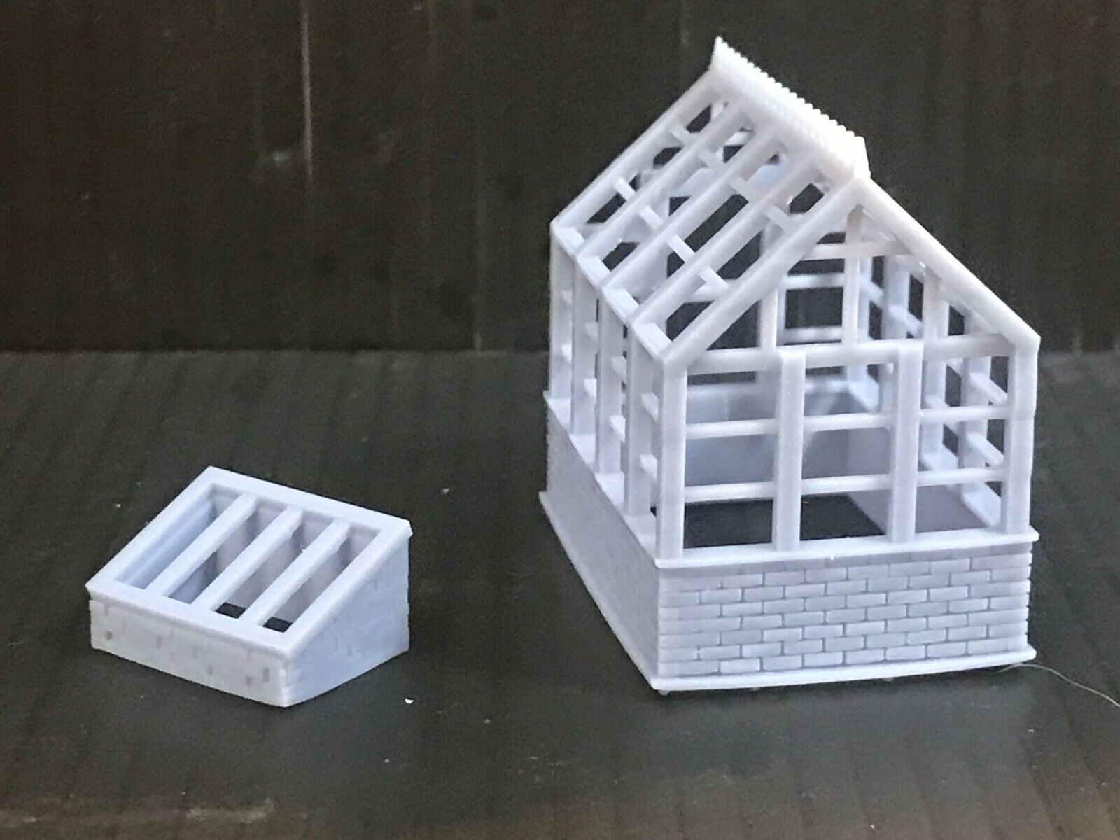 Unpainted 00 gauge resin kit with two Victorian-style greenhouses and two cold frames for model railway gardens