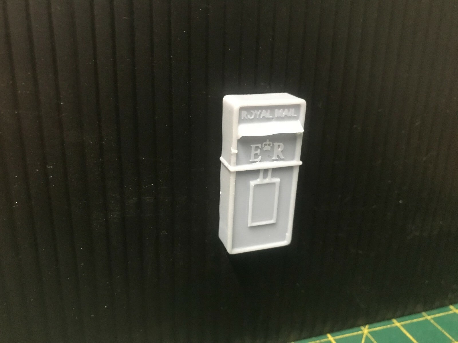 Unpainted G-scale and GN15 model postbox scenery set for narrow gauge railway layouts, including wall-mounted and freestanding boxes
