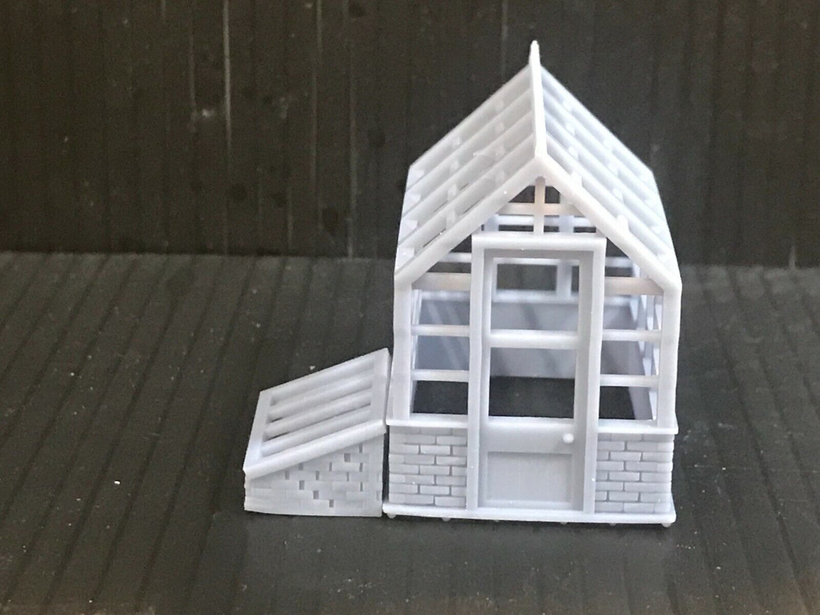 Unpainted 00 gauge Victorian-style model railway kit with two resin greenhouses and two cold frames, ready to assemble and paint