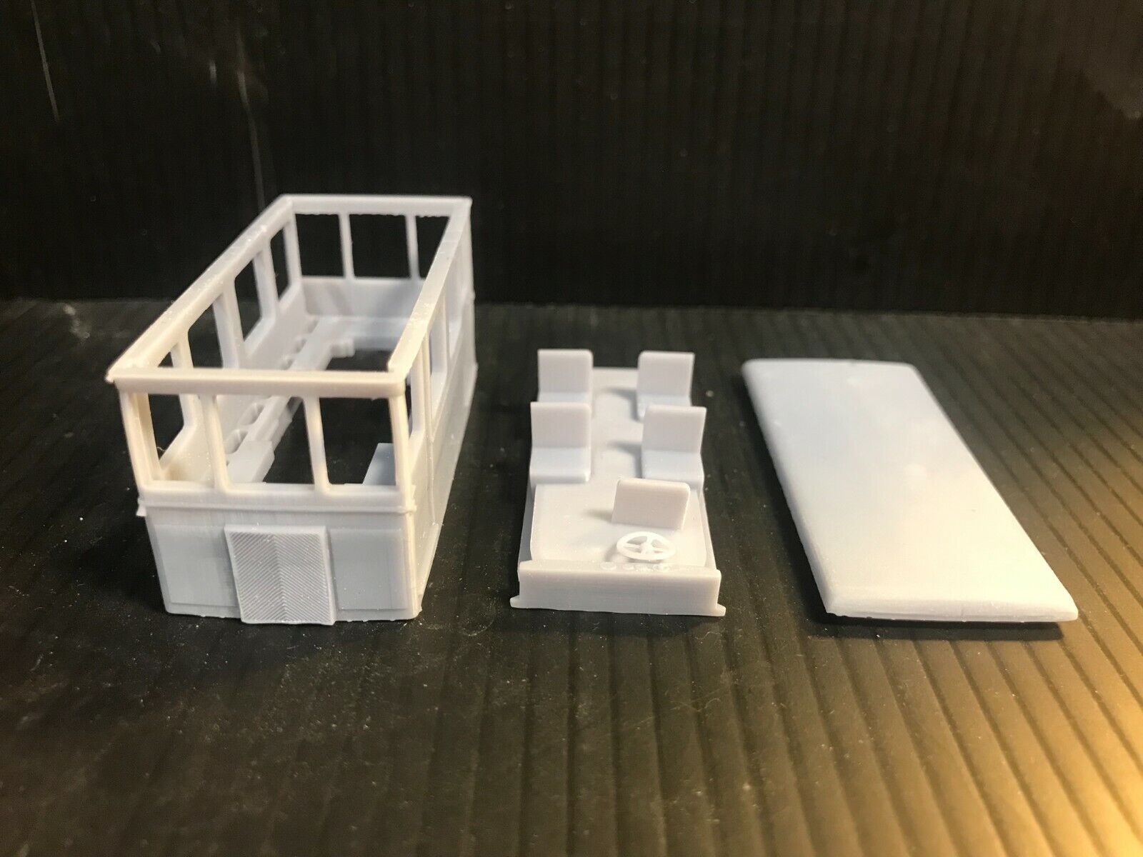 Unpainted OO9 narrow gauge French Drasine railcar body kit designed to fit a Kato 11-109 chassis, shown disassembled for detail