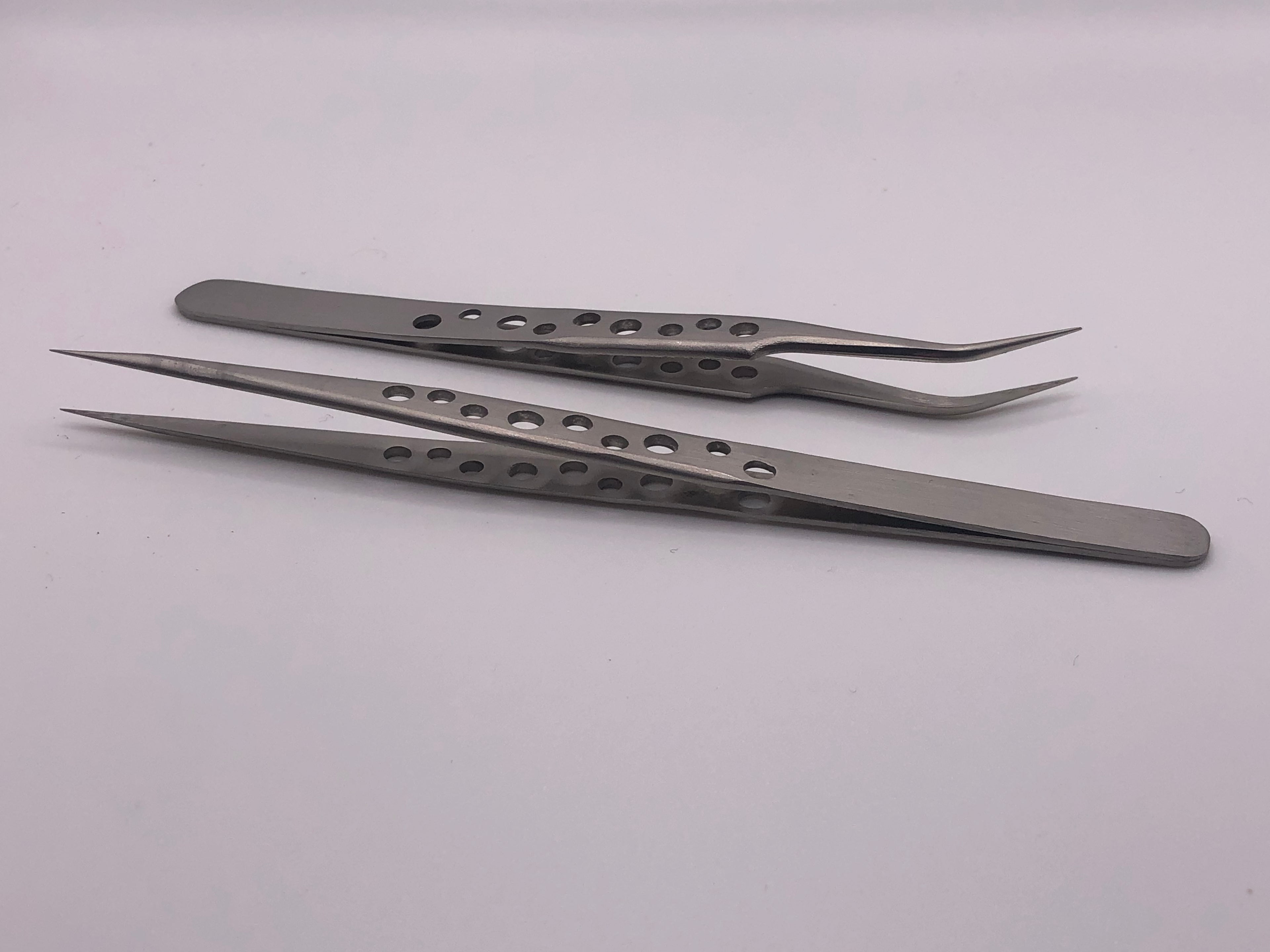 Pair of precision stainless steel straight and curved tip tweezers with drilled anti-static handles for detailed model railway work