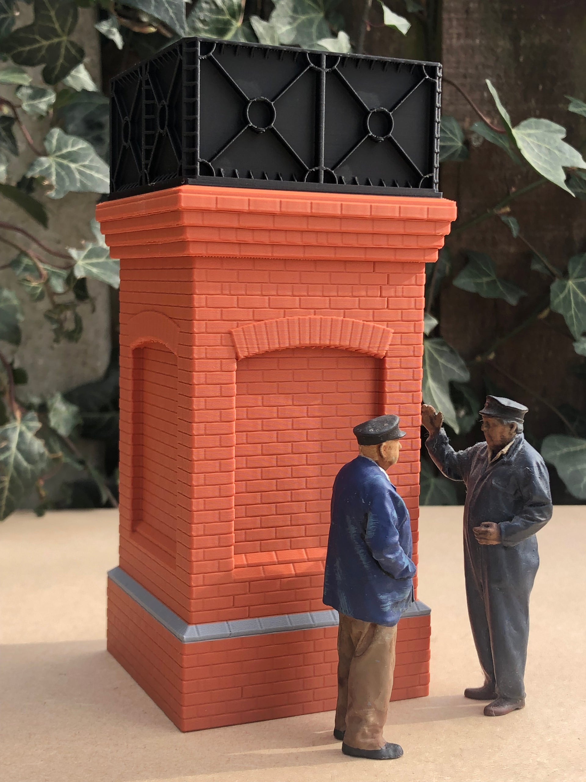 Unpainted but pre-coloured small brick water tower model for G Gauge or GN15 layouts, 3D printed as a single piece.