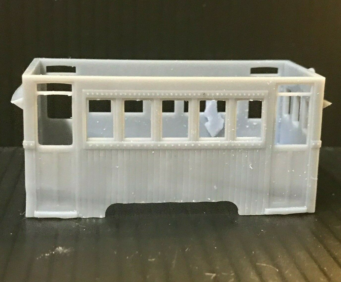 Unpainted OO9 narrow gauge prototype railbus body, roof and interior kit shown on a compatible Kato 103/109/105 chassis.