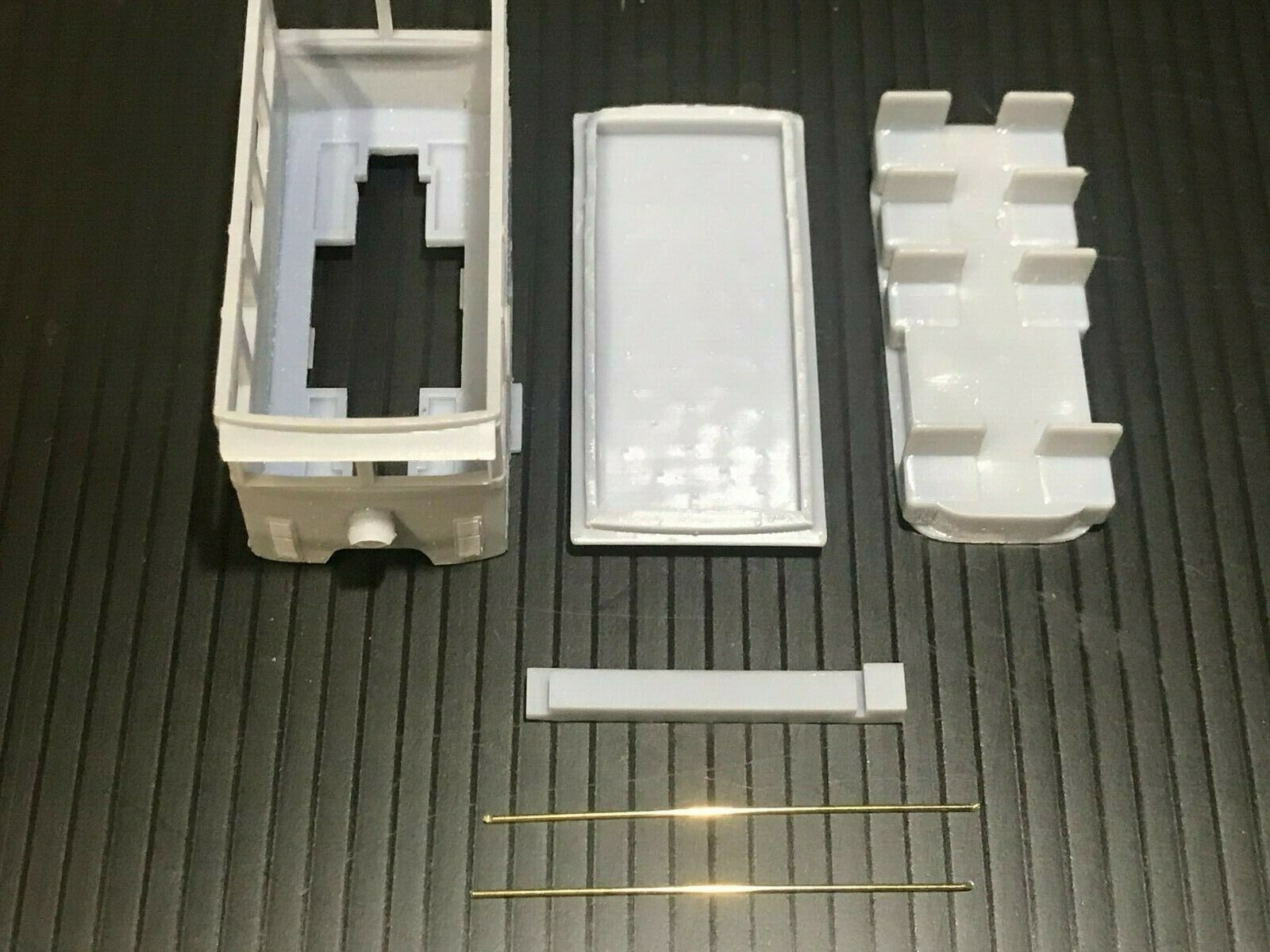 OO9 narrow gauge prototype tram railcar body kit shown on a Kato 103/109/105 chassis, with separate roof and interior seating.