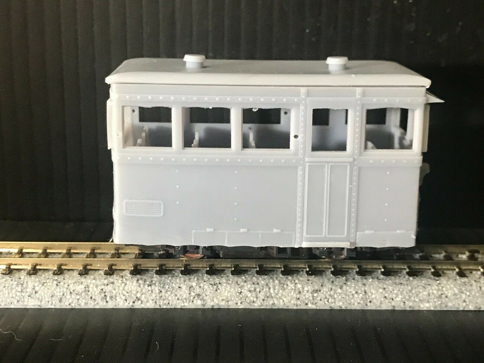OO9 narrow gauge prototype tram railcar body kit shown on Kato 103/109/105 chassis with separate roof and interior seating