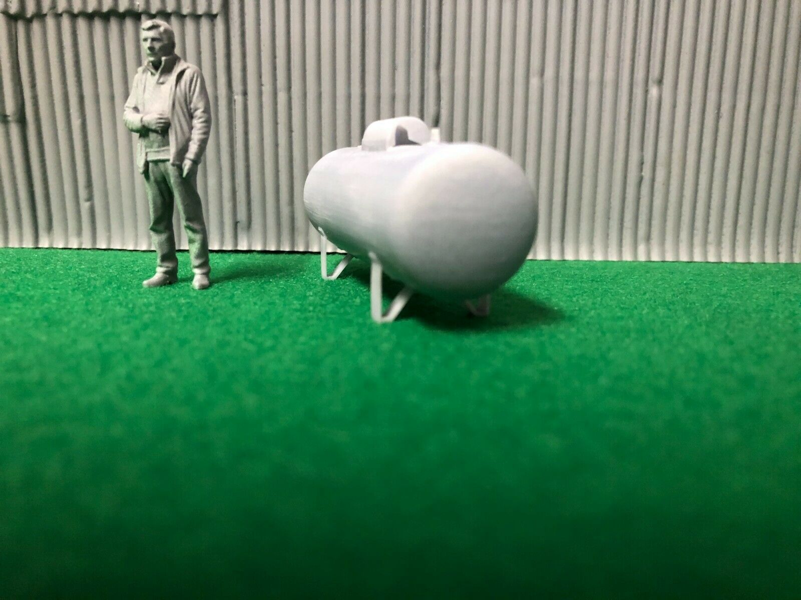 O scale unpainted resin propane tank with brass gas pipe wire and 3D-scanned figure for model railway scenery.