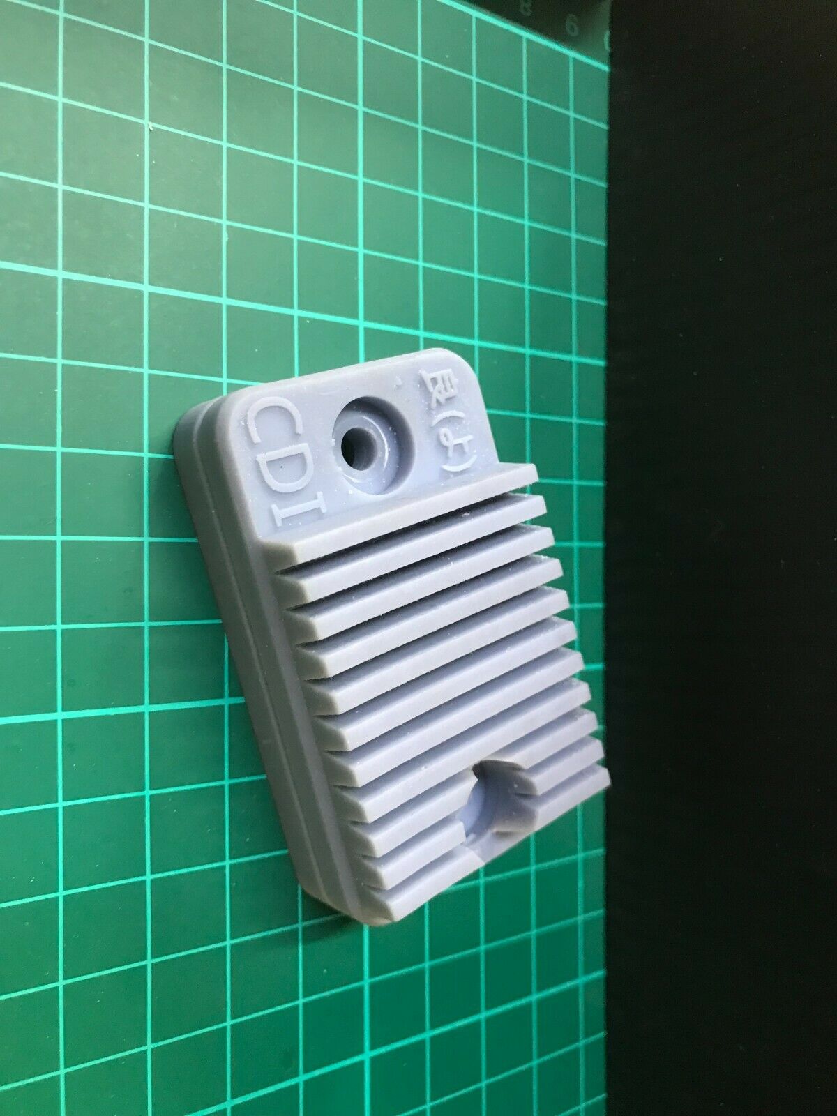Low-profile stealth case for an Apple AirTag, shown mounted for covert tracking on a car or motorbike.