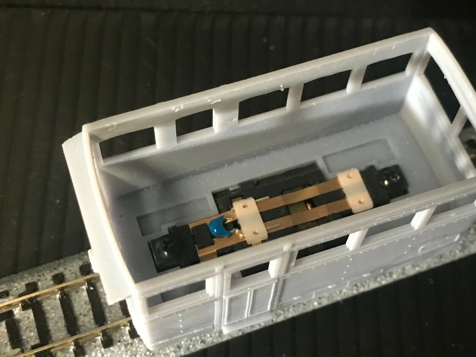 OO9 narrow gauge prototype tram railcar body kit shown on a Kato 103/109/105 chassis with separate roof and interior seating.