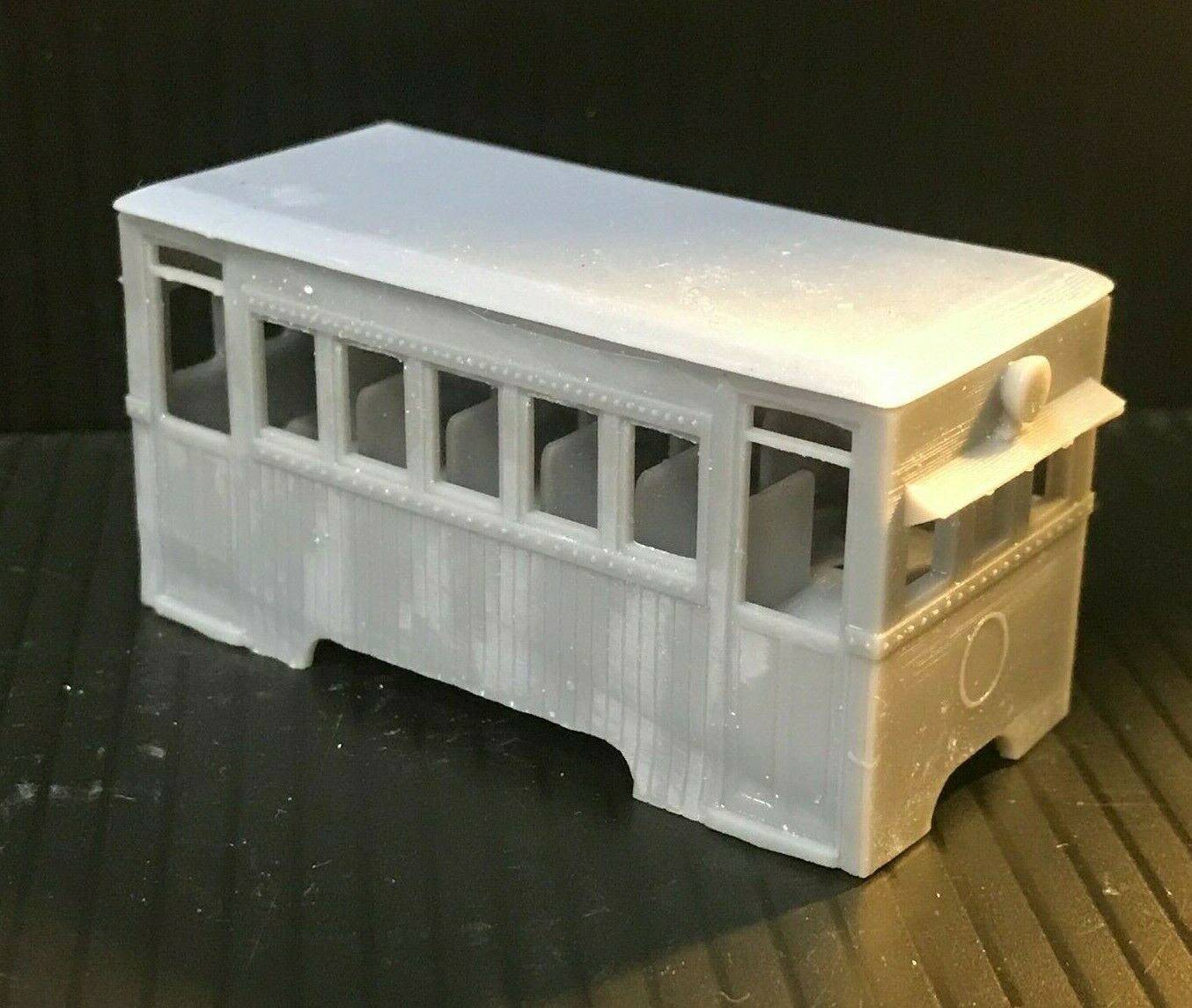 Unpainted OO9 narrow gauge prototype railbus body, roof and interior kit shown on a compatible KATO 103/109/105 chassis