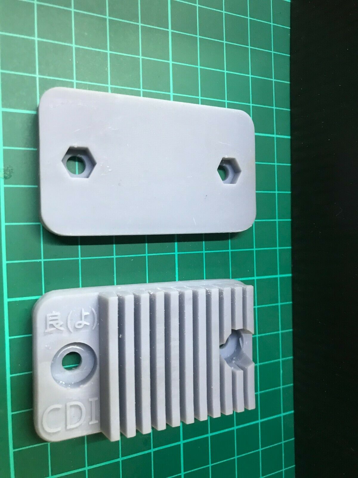 Low-profile stealth case for an Apple AirTag, designed for covert mounting on a car or motorbike.