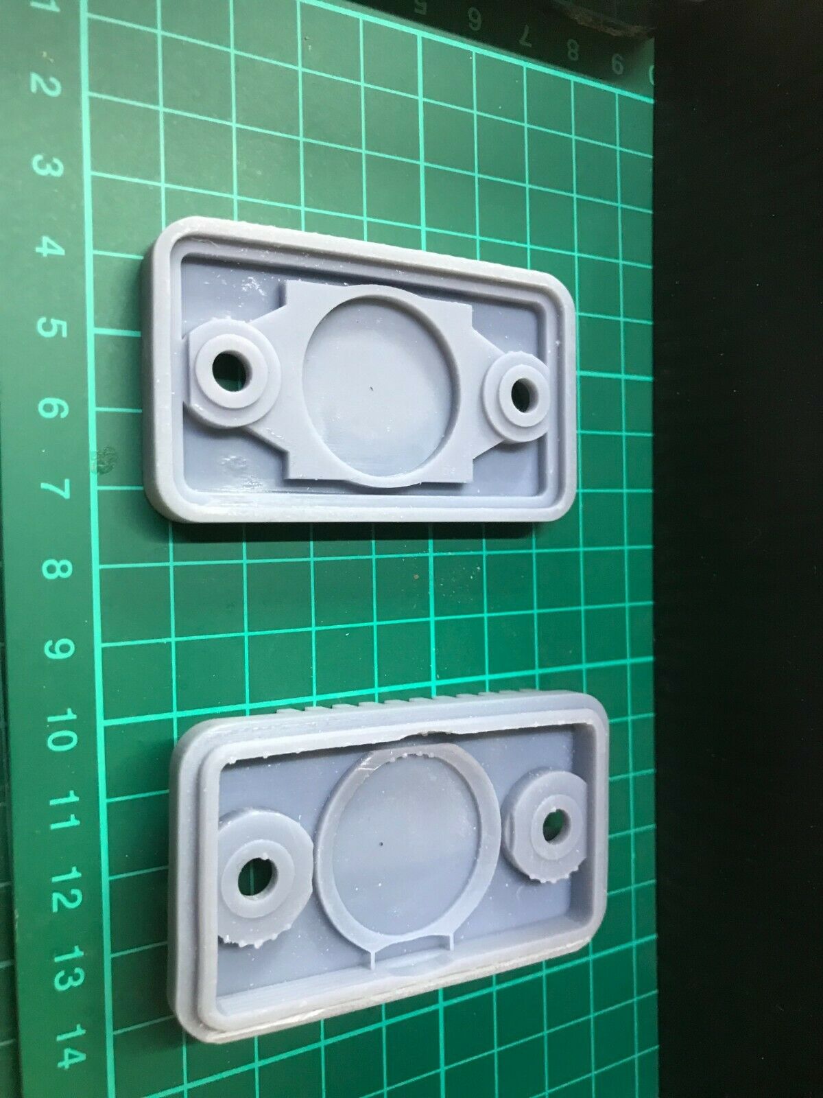 Low-profile stealth case for an Apple AirTag, shown mounted for discreet tracking on a car or motorbike.