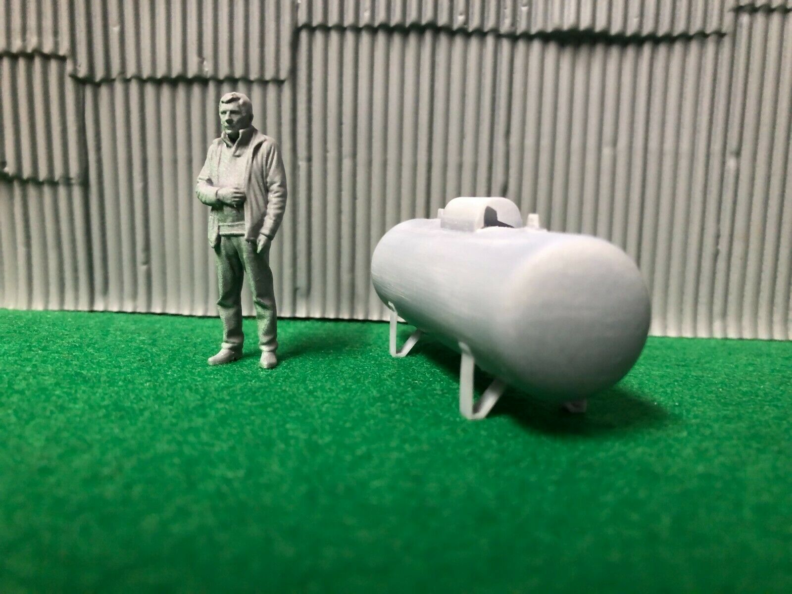 O scale unpainted resin propane tank with 3D-scanned figure and brass wire gas pipe for model railway scenery.