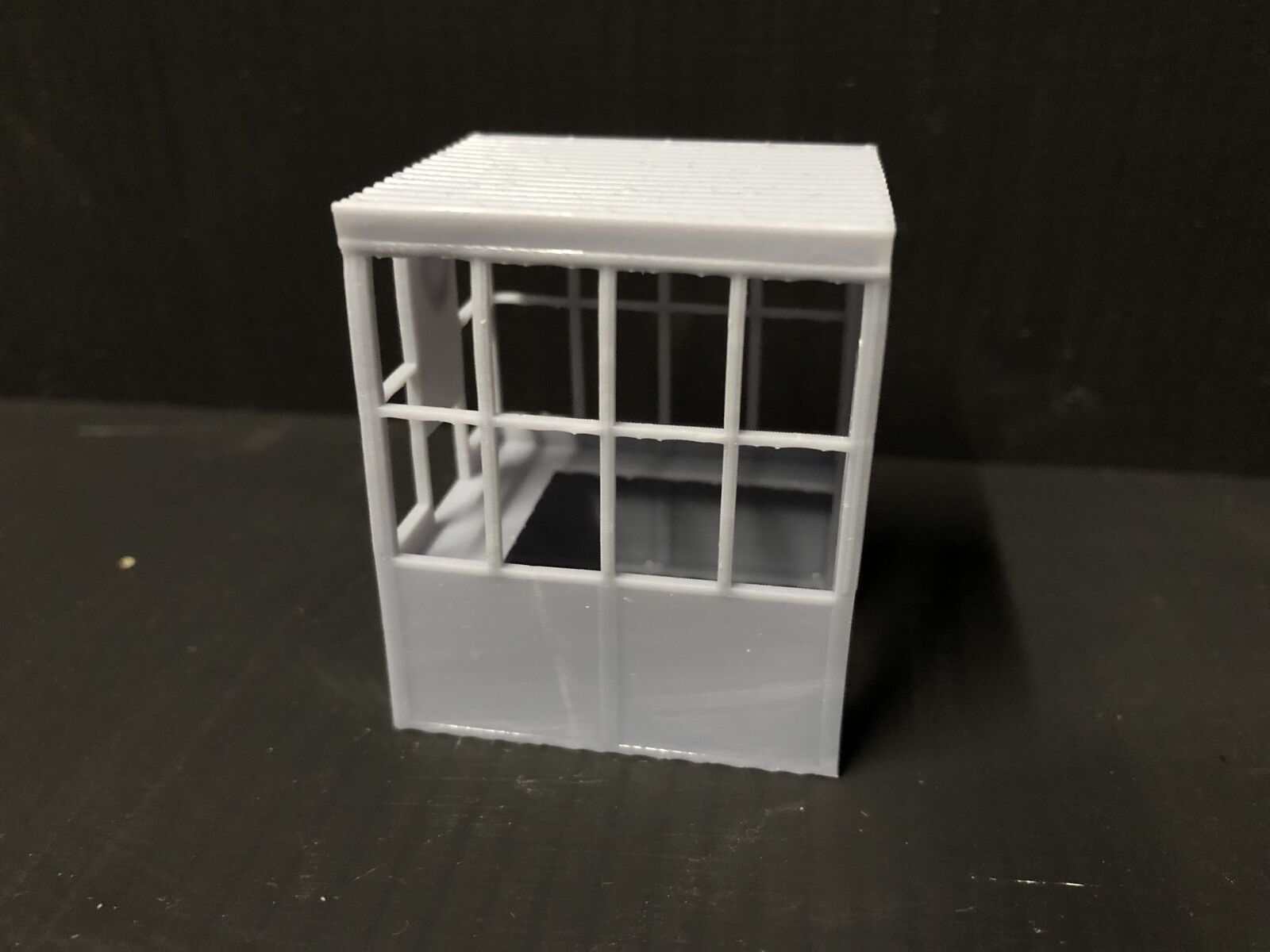 O / O16.5 7mm scale country petrol station kit with hut, two fuel pumps, owner figure and accessories for model railway layouts